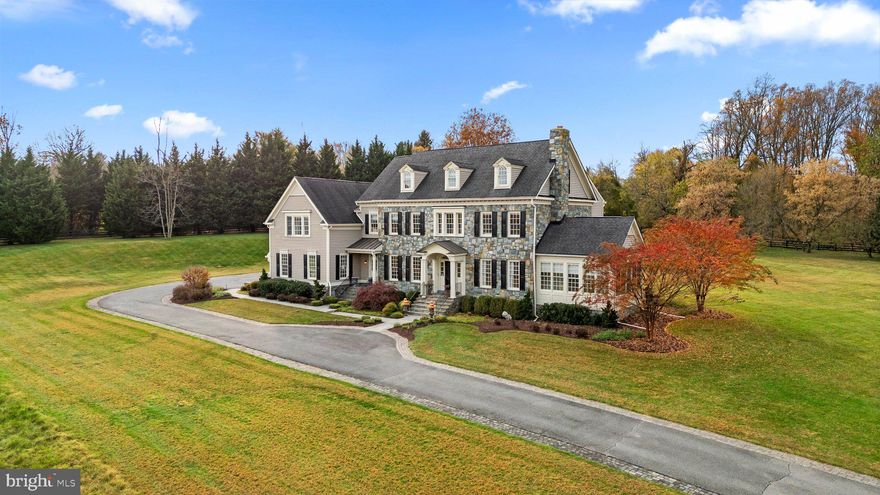 Welcome to a Dream Estate of Unparalleled Elegance and Serenity. Nestled on over 10 acres of breathtaking beauty in the prestigious Bancroft community of Sandy Spring, 17400 Ashton Green invites you to a life of luxury, sophistication, and tranquility. Positioned high on the property, this estate captures panoramic views of rolling landscapes and conservation areas from nearly every room, making it a rare treasure in this exclusive enclave of only 44 homes. The Eagles Nest, Mitchell and Best's largest model is designed to suit those who desire refined retreat-style living or the ultimate equestrian property. This extraordinary five-bedroom, five-and-a two-half-bath sanctuary spans over 9,000 square feet across four finished levels, displaying unparalleled  craftsmanship in every detail. Stepping into the grand two-story foyer, you are immediately captivated by the exquisite detailing: from designer accent moldings to lustrous hardwood floors. An elegant, curved staircase sets a regal tone for the residence. Just beyond, double French doors open to a private home office, perfect for refined work-from-home days. The main level offers an abundance of spaces for both intimate gatherings and grand entertaining. The cozy living room, complete with a wood-burning fireplace, flows seamlessly into the formal dining room, while a sunlit, serene sunroom offers an ideal spot to enjoy nature views or relax with a favorite book. The gourmet kitchen is a chef’s paradise, designed with inspiration in mind. Equipped with top-of-the-line appliances, a central island with breakfast bar, custom backsplash, double wall ovens, and a six-burner gas range, it’s a space where culinary dreams come alive.  This space opens to the family room, where  wall-to-wall windows with built-in benches, a tray ceiling, and a cozy stone surround gas fireplace, invite warmth and sunlight, igniting the imagination with stunning views of the estate's vast landscapes. A private rear staircase ascends to the first upper level, where you’ll find the opulent owner’s suite with its tray ceiling, step-down sitting room, two walk-in closets, and a private balcony--a tranquil retreat with commanding views. The luxurious ensuite bath  features a jetted tub, dual vanities, an oversized shower, and elegant tile flooring. Three additional bedrooms, including one with a private bath and two sharing a buddy bath, complete this level along with an open loft area, ideal for play or relaxation. The second upper level offers a fifth bedroom, another full bath, and a versatile open space that can serve as a craft room, additional office, or gathering area. The fully finished lower level extends the luxury living experience, featuring a recreation room with a stunning custom bar, game area, media room, exercise room, and a full bath. Walk-out stairs lead to a private backyard oasis, with lush landscaping carefully maintained by the HOA. The Bancroft community provides a peaceful setting with miles of walking paths, sidewalks, and a central neighborhood park with a tot lot. Don’t miss this rare opportunity to own a one-of-a-kind estate, impeccably maintained by its original owners and crafted with thoughtful detail throughout. This property stands as a testament to luxurious living, offering a retreat-like ambiance and a view that truly captivates.