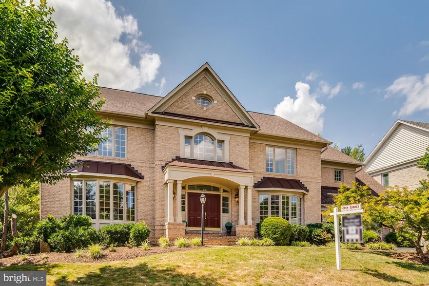 With nearly 6,000 square feet of finished living space, this Gorgeous Gulick-built home sits majestically on a .26 acre lot, promising grandeur from the moment you step inside. A grand center staircase welcomes you and sets the stage for what lied beyond this bright, two-story foyer. An open concept design invites you into a luxurious, inviting ambiance. 

On the main level, hardwood floors pave the way to an array of delights including a spacious, formal dining room, a dedicated office wit  built-ins & glass French doors, a spacious great room with loads of light & gas fireplace, a convenient laundry room, an updated powder room, ample storage spaces, and access to your 2-car garage complete the main floor. The gourmet eat-in kitchen is a chef's dream, adorned with stainless appliances and fixtures, a large island with granite topped breakfast bar, gas cooktop, double ovens, a built-in microwave, and work station. French doors lead you to the newly repainted rear deck (2024), for outdoor relaxation & enjoyment.

Ascending to the upper level, newer carpet graces four bedrooms and three full bathrooms & an overlook to the great room! The primary suite is a sanctuary with a bay window, sitting area, spacious walk-in closets, deep soaking jacuzzi tub, new frameless glass enclosed separate shower, dual vanities, and water closet. The upper level bedrooms feature walk-in closets and ensuite bathrooms, including one Jack and Jill style bathroom. A second staircase conveniently connects the upper level to the kitchen/living space.

The walk-out lower level boasts an expansive rec room, two additional bedrooms (including an in-law suite), and a bonus room, providing ample space for relaxation and entertainment. Step outside to your backyard oasis.

Nestled on a cul de sac in the highly sought-after Carrington community, residents enjoy scenic wooded trails to Wolf Trap, tennis courts, well-lit sidewalks, freshly paved streets, new mailboxes, and a playground. Located in esteemed school districts, with easy access to major transportation routes including Route 7, the Dulles Toll Road, and I-495, making a commute to DC or Dulles Airport a breeze.  Spring Hill Metro station (Silver Line) is less than a mile away (with walking/bike trails), and with Tysons Corner Mall,  The Galleria, and the Boro offering an array of dining, shopping, and entertainment options nearby, this home is a CATCH!

Additional updates include partial window replacement, new garage doors, main and lower level repainting (2024), ROOF replaced 2 years ago; water heater and one hvac replaced 2018, upper level new carpet (2024), and more....partially fenced back yard, too! Last 3 homes in Carrington sold for $1.9, $2M and $2.1M