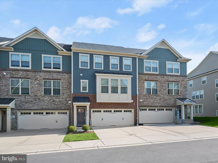 Step into luxury living with this exquisite 2020-built townhome in the sought-after Parkside community. Boasting three levels and a one-car garage, this residence is a cut above the rest. Experience the epitome of elegance with upgrades galore, including engineered hardwood flooring, recently replaced carpeting, and stylish lighting fixtures that further illuminate the sun-filled interiors. The open concept main level features a kitchen adorned with 42-inch soft-close cabinetry, undermount lighting, quartz counters, a tile backsplash, stainless steel appliances, two pantries, and a spacious island with stylish pendant lighting, and a breakfast bar. Entertain in style with a dining area and adjacent butler's pantry equipped with a beverage refrigerator. The living room is adorned with an accent board and batten grid wall, leading to a sunroom with deck access through a sliding glass door. Revel in outdoor bliss on the largest composite deck in the community. The upper level houses a primary bedroom with a sitting room and a walk-in closet complete with a closet system. The primary en-suite bath showcases a double vanity and a tiled shower with a frameless glass door. Two additional bedrooms that have closets with built-ins, a full bath, and a convenient laundry room complete the upper level. The lower level beckons relaxation with a family room, fourth bedroom, and another full bath. The finished garage boasts painted walls, epoxy floors, and ample storage. Enjoy community amenities like a clubhouse, fitness center, pool, and playgrounds. Conveniently located near commuter routes, Fort Meade, BWI Airport, shopping, dining, and entertainment, this home offers a lifestyle of unparalleled comfort and convenience.