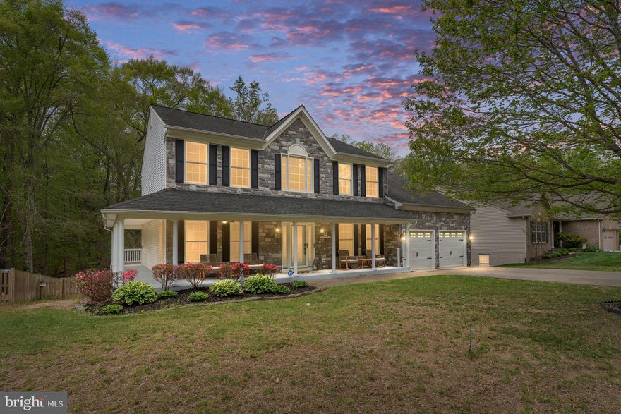 Tucked away on a quiet cul-de-sac in the sought-after Cardinal Forest community, this expansive stone-front home offers the perfect blend of space, comfort, and convenience just minutes to I-95, commuter lots, the VRE, shopping, dining, and only a short drive to historic downtown Fredericksburg.

With over 4,700 square feet across three fully finished levels, this 5-bedroom, 3.5-bath home is designed for both everyday living and entertaining. A welcoming covered front porch that partially wraps around the home sets the tone, while inside you’re greeted by soaring two-story ceilings, 9+ foot ceilings, hardwood flooring, and an abundance of natural light.

The main level features a spacious layout with a sunroom bump-out, a family room with a wood-burning fireplace, and an upgraded kitchen complete with a center island, wall oven, and built-in cabinetry. The formal dining room showcases a bay window and leads into the generously sized sitting room, while a separate office with French doors provides a quiet, functional workspace. A bay-style door off the eat-in kitchen leads out to a massive deck overlooking a private, tree-lined and fenced in backyard, ideal for relaxing or hosting.

Upstairs, the primary suite offers a true retreat with a sitting area and sunroom bump-out, tray ceiling, and a large en-suite bath featuring a soaking tub, walk-in shower, dual vanities, and a custom walk-in closet with built-ins. Additional bedrooms are generously sized, and detailed finishes like crown molding, chair rail, and recessed lighting carry throughout the home.

The fully finished walk-out basement expands your living space even further with a full bedroom and bath, multiple living and recreation areas, plus a bar and second kitchen setup, perfect for guests, entertaining, or multi-generational living.

Situated on a beautifully landscaped lot backing to trees, this home also includes a 2-car attached garage and access to Cardinal Forest amenities including a pool, basketball courts, tennis courts, tot lots, and playgrounds.

A rare combination of size, location, and features, this home checks all the boxes.