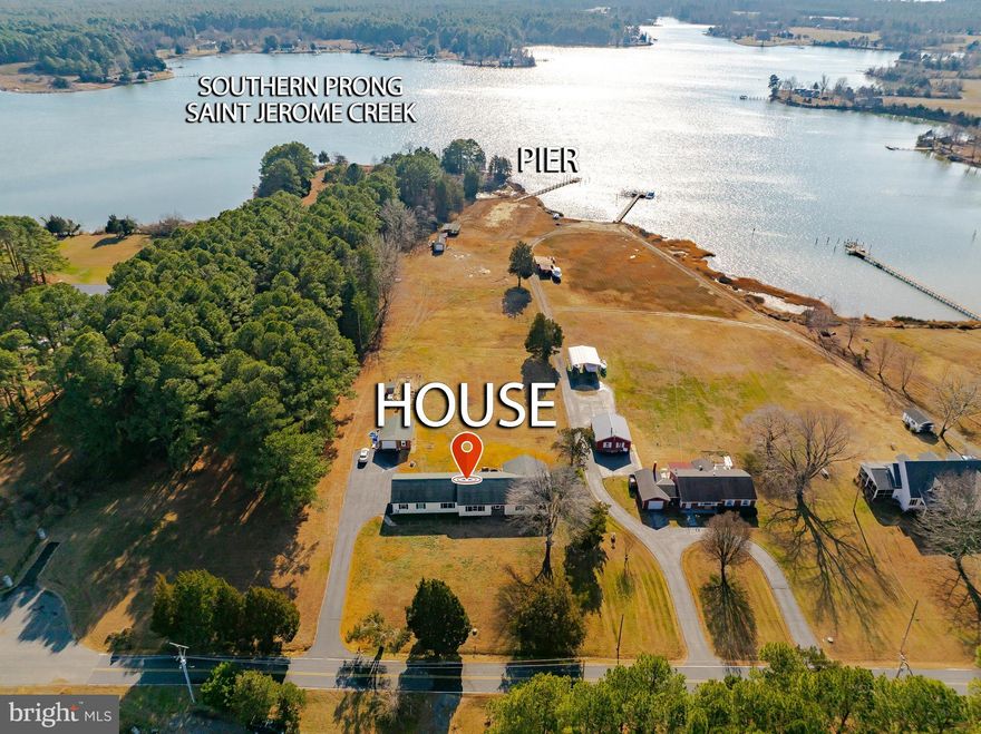 If you've been looking for peace and tranquility then this waterfront ranch-style home is for you. With front AND back views of St. Jerome Creek, every room is special.  Built in 1997, this well-maintained residence welcomes you with a spacious foyer that leads to the formal living room on the front of the house and the family room off the back. The kitchen has been updated with a beachy theme adding counter space for elaborate meals, storage and breakfast area. The formal dining room will host many guests and the mudroom gives you easy access to the backyard. The other side of the home boasts 3 well appointed bedrooms, all with large closets and views. The primary bedroom includes a luxury bathroom, walk in closet plus 2 additional closets and a picture window overlooking the creek and yard. The attached garage gives you staired access to the huge attic and the crawl space with concrete flooring  Outside, the property is all about casual creek living. With a boathouse for your watercraft and fishing/crabbing supplies, shed for storage and a detached garage used as a cottage in previous years., you can enjoy peaceful views and the soothing sounds of nature right from your backyard or the pier where you can tie off up to 2 boats.  This home is not just a place to live; it's a lifestyle.