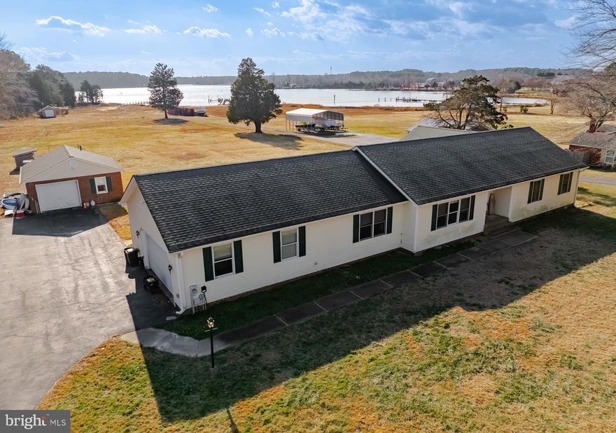 If you've been looking for peace and tranquility then this waterfront ranch-style home is for you. With front AND back views of St. Jerome Creek, every room is special.  Built in 1997, this well-maintained residence welcomes you with a spacious foyer that leads to the formal living room on the front of the house and the family room off the back. The kitchen has been updated with a beachy theme adding counter space for elaborate meals, storage and breakfast area. The formal dining room will host many guests and the mudroom gives you easy access to the backyard. The other side of the home boasts 3 well appointed bedrooms, all with large closets and views. The primary bedroom includes a luxury bathroom, walk in closet plus 2 additional closets and a picture window overlooking the creek and yard. The attached garage gives you staired access to the huge attic and the crawl space with concrete flooring  Outside, the property is all about casual creek living. With a boathouse for your watercraft and fishing/crabbing supplies, shed for storage and a detached garage used as a cottage in previous years., you can enjoy peaceful views and the soothing sounds of nature right from your backyard or the pier where you can tie off up to 2 boats.  This home is not just a place to live; it's a lifestyle.