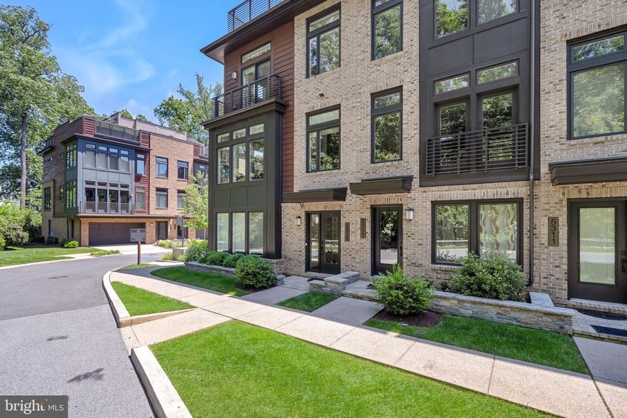 Welcome to your own private oasis in the heart of Grosvenor Heights! This luxurious 4 bedroom EYA townhouse offers the perfect blend of modern elegance and natural serenity. Nestled among the trees, this end-unit townhouse boasts breathtaking, panoramic  views of the surround tree tops - creating a truly unique living experience in a convenient Bethesda location.

A gourmet kitchen features a center island with Thermidor, SubZero and Miele appliances. With two walls of floor-to-ceiling windows surrounding the living and dining rooms, this entire living space is flooded with natural light and views of the surrounding landscape. A linear gas fireplace with stone mantel and wet bar create the mood for cozy nights at home or entertaining your friends and family.

The primary bedroom is a true sanctuary, boasting  a charming Juliet balcony that offers views of the lush landscape outside of your front door, creating a serene retreat right at home. Two walk-in closets with custom built-ins provide ample storage and an en-suite bathroom features a double sinks and shower. This level also features two additional bedrooms, and a well-appointed hall bath with relaxing bathtub. For added convenience, a dedicated laundry area completes this floor, ensuring that daily tasks are effortlessly managed.

The entry level of the home features a large, welcoming foyer,  hall closet and a light filled room with a full bathroom. Perfect for a home office, a gym or a bedroom - the walls of windows in this room make it a lovely space to spend time in.  Prefer privacy? This room features remote window shades that allow for light but privacy as well.

Entertaining is a delight with an outdoor roof-top  patio designed for luxury living. Complete with a built-in kitchen, sink refrigerator and outdoor TV - hosting gatherings is an effortless pleasure!  A retractable awning and a gas fireplace allow for this space to be used throughout the year and in any weather. The built-in gas grill with gas hookup ensures that you'll never have to worry about running out of propane in the middle of preparing your meal again! The elevator services this level of the home as well making it easy for all owners and guests to enjoy this space.

Convenience is key, with easy commenting options via Metro stations at either Bethesda or Grosvenor-Strathmore stations and Pike and Rose and Bethesda with their boutiques and restaurants are a short distance away. For outdoor enthusiasts, the proximity to nature trails and bike trails provide endless opportunities for fresh air and adventure.

With it's thoughtful design and modern features, this townhome offers a tranquil and stylish living experience that's sure to impress.