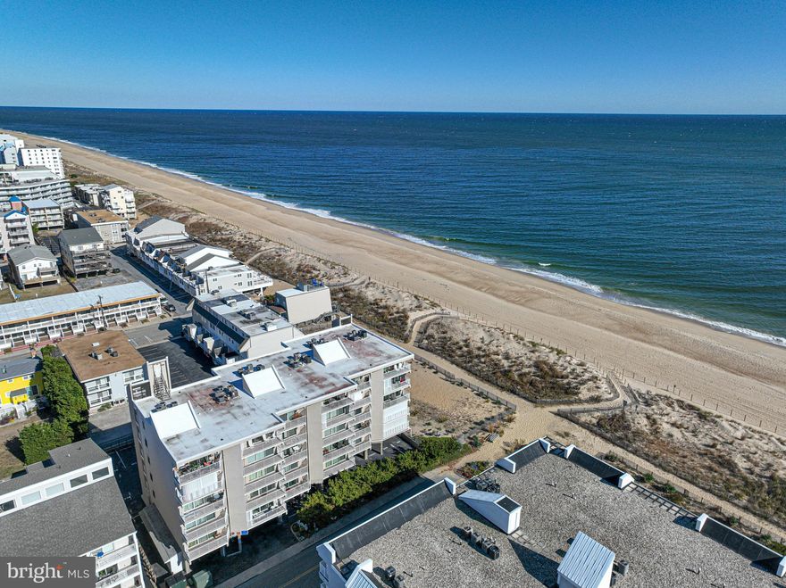 A little slice of heaven on the beach at 77th street. This small well maintained building has a lovely deck and community garden area, picnic table and grills. Adorable 2 bedroom, 2 bath condo with nice ocean and dune view. Southern exposure. Sold as is. Turn key fully furnished. New HVAC and bathrooms in 2021.  Newer appliances.  NEW hot water heater 2024.  Sliding Shades to cover complete sliding doors to the balcony for extra privacy. Great midtown location. Many wonderful restaurants and shops within walking distance. Call today for a personal showing and start living your dream at the beach!