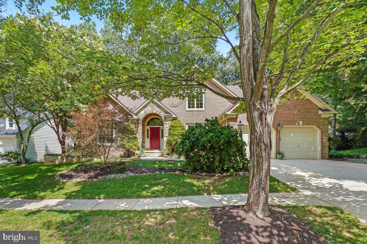 Welcome to Your Dream Home in River Hill! Tucked away on a quiet, tree-lined cul-de-sac this stunning brick and stone-front colonial is the perfect blend of elegance, comfort, and craftsmanship. From the moment you arrive, you'll be captivated by the beautiful arched entryway and slate hardscaping that sets the tone for what’s inside. Step into a sunlit two-story foyer and take in the gorgeous, stone-look ceramic tiling, gleaming hardwood floors, soaring vaulted ceilings, and refined finishes throughout. The chef’s kitchen is a true showstopper, boasting high-end appliances, rich custom cabinetry, granite countertops, and a large island with a unique copper top, all illuminated by artist-crafted glass pendant lighting. Adjoining the kitchen is a perfect table space with sliding glass doors that access a deck. Just adjacent from the kitchen is the inviting family room that features expertly crafted display cabinets and bookcases, a vaulted ceiling and a gas fireplace framed by Palladian glass windows that frame tranquil, wooded views.The first-floor primary suite is a luxurious retreat featuring vaulted ceilings, a wall of windows and two walk-in closets. The primary bath is equally as stunning with a unique stone entry to a beautiful glass framed shower, separate soaking tub, and dual vanities. The large living room boasts vaulted ceilings and a gorgeous Palladian window and the devoted dining room features stunning chair railing and crown molding details. A spacious powder room completes the main level. Upstairs, an airy landing overlooks the family room and leads to three generously sized bedrooms, each with walk-in closets. The front bedroom features vaulted ceilings, and the two others include ceiling fans. A shared full bath serves this level. The full, unfinished walk-out lower level offers endless possibilities for customization, with rough-in plumbing for an additional bathroom and double glass doors that open to the serene backyard. Outdoor living is just as impressive with a screened-in porch, contoured deck, and a slate patio perfect for entertaining or quiet evenings in nature. Bonuses include custom window blinds and shutters with blackout blinds for the upstairs bedrooms, new AC and furnace, 2016 roof with lifetime warranty and electric car charging port in the garage. This extraordinary home is a true gem- the perfect blend of luxury, comfort, and timeless design in one of the area’s most desirable communities!  It is an absolute MUST SEE!!