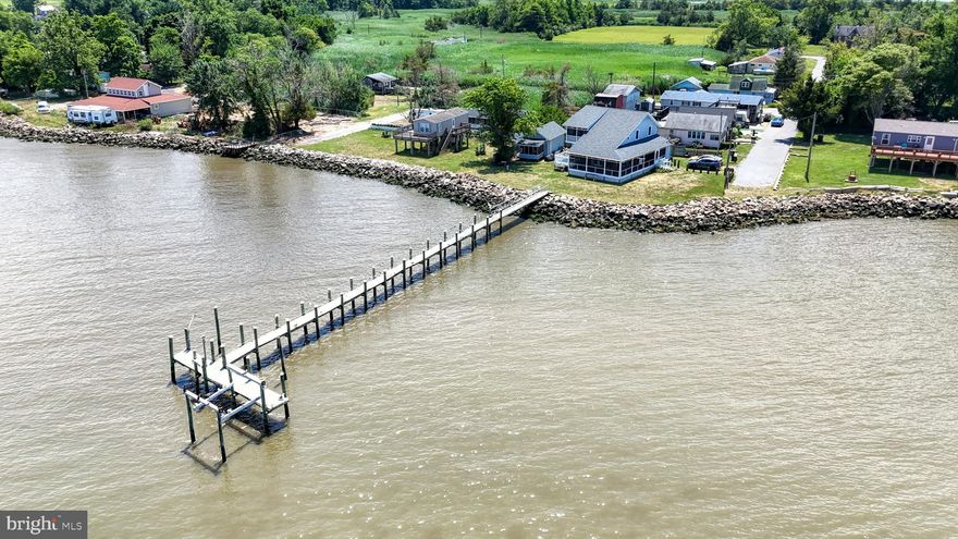 Are you looking for a water front property?  Great getaway for anyone who is a serious hunter or fisherman. Then look no further. The beauty starts with the view. This home sits right on the Delaware Bay and is the only property with access to  a private dock (per the seller) that extends into the bay. Great for crabbing, fishing, boating and just relaxing as you watch the birds and the dolphins play. The boat lift is as is. This is so much more than just a home, it is a lifestyle. Enter the screened in porch that wraps around half the house.  Can you think of a better way to enjoy a morning cup of coffee or an evening glass of wine than sitting there looking at the water and listening to nature? Enter the home and the pride of ownership greets you at the door. Flooring is all Low Density Vinyl Plank (LDVP) for beauty and durability. To the right is a beautiful kitchen boasting quartz countertops, stainless steel appliances and an ample supply of cabinets for storage. Flowing off the kitchen in this open floor plan is the breakfast nook making meals convenient and easy. Next the family room features a vaulted ceiling and french doors leading to the wrap around porch overlooking the bay. The dining room (can be easily converted into a 3rd bedroom) also has french doors leading to the same porch. Wrapping up the first floor is the laundry room and a full bath with a walk in shower. Upstairs the primary bedroom boasts a large walk in closet and another set of french doors that lead to a private deck overlooking the Delaware Bay (another great place for coffee or wine). The full bath can be entered from the primary bedroom and from the hall and offers a beautiful updated walk in shower. The guest bedroom has a walk in closet as well. What more could you ask for? Move in and unpack, you are home.  Back on the market due to financing issues. Owners are in the process of getting the permit for the dock from DNREC once they have that then they can do the work DNREC asks for and get the lease. We do not have a time table.