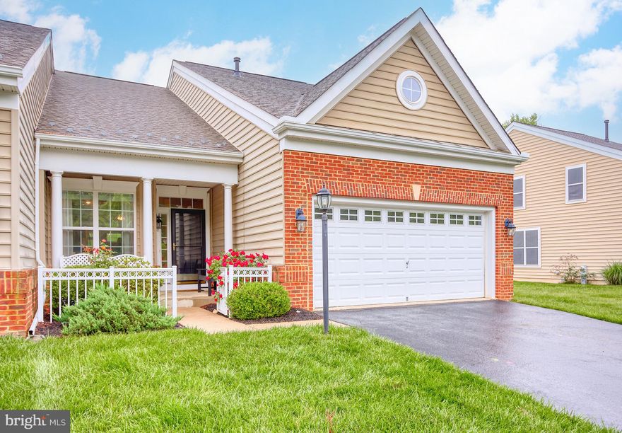 Welcome to this bright and spacious end-unit villa, designed for easy, low-maintenance living with amazing community amenities! The open-concept main floor features a stylish kitchen with stainless steel appliances, granite countertops, and a cozy breakfast nook with a wooded view. Enjoy hardwood floors and a stunning two-story family room with a gas fireplace. Two sliding doors lead to a maintenance-free Trex deck overlooking a lush backyard. The main floor primary suite includes a remodeled en-suite bath, while a second bedroom, full bath, and convenient laundry/mudroom are nearby. Upstairs, a third bedroom, full bath, and large loft offer flexible space for work or play. The unfinished basement provides endless possibilities for additional living space. Homeowners painted the entire interior 2 years ago, replaced the kitchen sink faucet and a new A/C unit was installed Spring 2024. This home offers the perfect blend of comfort and style—come see for yourself! The community has a 37,000 sq ft Residents' Club with full gym, indoor and outdoor pools, billiards room, tennis and pickleball courts and more. Snow and trash removal are included and enjoy resident discounts at nationally-ranked Bulle Rock Golf Course. Don't miss out on this exceptional opportunity to live in one of the most desirable gated communities in the area!