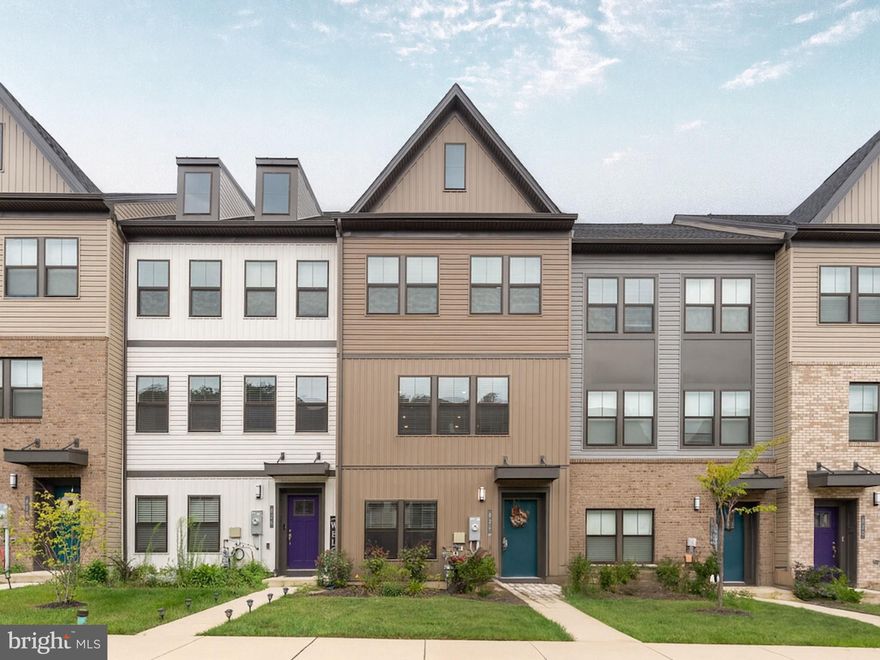 Great news! The seller is now offering an $8,000 credit to help reduce your interest rate or cover closing costs. Reach out for detailed 2-1 buy-down scenarios based on your down payment and see how much you can save each month.

Discover 824 Teacher Mitchell Road – a beautifully designed, four-level townhome with a rear-loading two-car garage in the coveted waterfront community of Tanyard Shores (all ages). Offering 4 bedrooms, 2 full baths, and 3 half baths, this home blends smart design with modern finishes and abundant natural light.

On the main level, the heart of the home is the chef’s kitchen, complete with a gas range, stainless steel appliances, and a striking 13-foot granite island—ideal for both meal prep and gathering with friends. An open floor plan connects the kitchen to the spacious living room and composite deck, creating a seamless space for entertaining. On the opposite side, a bright dining area offers plenty of room for a large table, a cozy reading corner, or even a home office.

The upper level hosts the primary suite, two additional bedrooms, a full bath, and a conveniently located laundry room. The entry level is perfect for a home office, gym, or guest bedroom, plus a half bath and direct garage access. The top level is a true showstopper—an airy loft with its own half bath that opens to a rooftop deck, perfect for sunset cocktails or relaxing weekend mornings.

Life in Tanyard Shores includes access to an incredible array of amenities: a 5,000 sq ft clubhouse with resort-style pool and pool house; state-of-the-art fitness center; coffee bar; lounge with kitchen; children’s playroom; patio and outdoor dining areas; tot lot; dog park with wash station; outdoor game area; fire pit; scenic hiking trails; wildlife preserves; and a waterfront beach area with kayak storage and pier for easy adventures on the water.

Just minutes from shopping, dining, and major commuter routes—and within easy reach of Fort Meade, NSA, and the National Business Park—this home delivers the perfect blend of luxury, convenience, nature, and community.

And don’t forget — the seller is offering an $8,000 credit that can be used toward a 2-1 buy down or closing costs. Contact me for full payment scenarios based on your down payment.