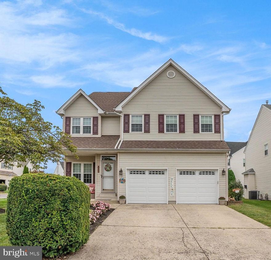 Welcome to this spacious 4-bedroom, 2.5-bath colonial. From the moment you step onto the covered front porch, you’ll feel right at home. Inside, the formal living room features gleaming hardwood floors and an abundance of natural light, flowing seamlessly into the formal dining room—perfect for holiday gatherings and dinner parties. The eat-in kitchen is the heart of the home, offering a center island, gas cooking, built-in microwave, under-cabinet lighting, tile floor and backsplash, a large pantry, and plenty of counter space.  A sliding glass door leads to the newer (2021) maintenance-free deck overlooking the fenced backyard. Just off the kitchen, the impressive two-story family room is anchored by a cozy gas fireplace and expansive windows with remote-controlled blinds.  A large coat closet, convenient laundry room, and half bath finish the main level.  Upstairs, the primary suite is a true retreat with two walk-in closets and a spacious bath featuring a jetted tub, double sinks with a lighted mirror, and a stall shower. Three additional bedrooms and a full hall bath complete the second level. The large landing overlooks the family room below and offers two linen closets for added convenience. The finished basement provides a spacious living space, complete with two large utility rooms and a separate area ideal for a home office.  A two-car attached garage offers both parking and storage.  Recent upgrades include a new heater/AC (2025), hot water heater (2024) and a 35-year guarantee roof (2024). Located close to shopping, dining, and major commuter routes, this home combines comfort, style, and convenience—don’t miss it!