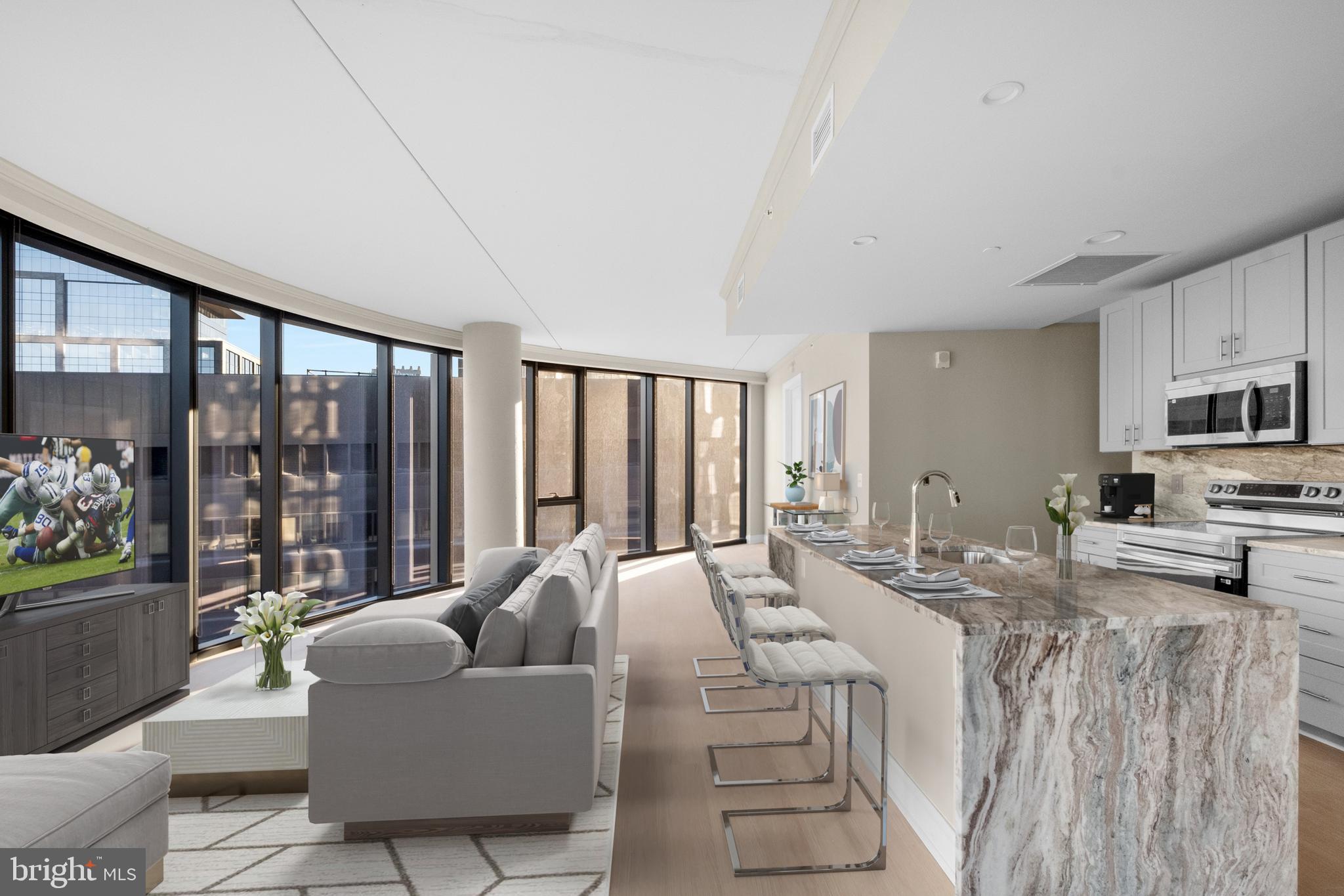 Experience the epitome of LUXURY LIVING at 2301 JFK, Philadelphia's premier ALL-GLASS residential tower. This 3-bedroom, 3-bath apartment offers BREATHTAKING VIEWS from sunrise to sunset, encompassing the city skyline, waterfront, and the World-Famous Boat House Row.
The spacious and open living and dining areas, are PERFECT FOR RELAXATION AND ENTERTAINMENT. The custom kitchen features a large breakfast bar, abundant cabinet and counter space, marble backsplash, and stainless-steel appliances.
Each bedroom boasts it’s own LUXURIOUS marble bath, and you will just love the hardwood floors throughout.
2301 JFK offers a ROOFTOP GYM with state-of-the-art equipment, ROOFTOP lounge with Wi-Fi, and ROOFTOP POOL, with UNMATCHED and UNRIVALED VIEWS. Complimentary bike storage, sports courts with basketball, volleyball, pickleball, squash, badminton, paddle tennis and soccer. 24 hr front desk with package acceptance and secure entry. Onsite dog park area, GARAGE PARKING for an additional fee, and convenient access to Penn, Drexel, CHOP, 30th Street Station, Giant supermarket, and the Schuylkill River Trail; you will just love calling 2301 JFK your new home! Please note: Photos shown are of a model unit. Actual finishes and layout may vary.