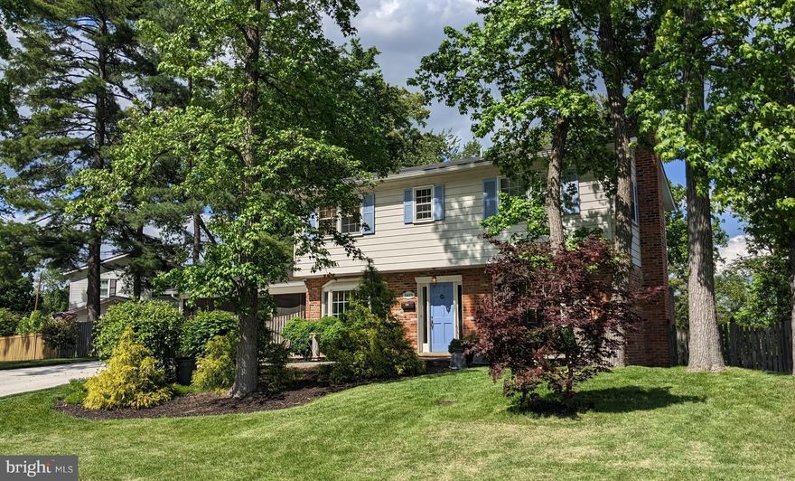 What a totally charming home!   Situated on a premium lot with beautiful landscaping, this is an idyllic retreat.  From the expansive screened porch walking out to the large stone patio, there's opportunity to spread out, entertain family and friends, or just to relax in the peaceful environment.  The large yard has plenty of sunshine--with shade in just the right places.  There are flower gardens and vegetable gardens as well as a delightful little fish pond. *** Walking into the front foyer you'll feel the traditional charm of this home.  There's a large living room and a comfortable dining room, both with large Marvin bay windows added in 2011, and hardwood floors.  The half bath on this level was just updated and the beautiful kitchen was completely remodeled in 2021 with white cabinetry, quartz countertops, and stainless steel appliances! *** Upstairs are four nice bedrooms and two full updated baths.  The primary bedroom has an ensuite bath and all the rooms have hardwood floors.  *** The basement level is finished with a rec-room space, an office alcove, a large laundry room, and a great Bonus Room or possible 5th bedroom.  Also on this level are a utility room, a tool closet, and a nice storage space complete with shelving that conveys.  From this level one can exit a back door to walk up to the rear yard and gardens. ***  Come see this wonderful home and perhaps make it your own.