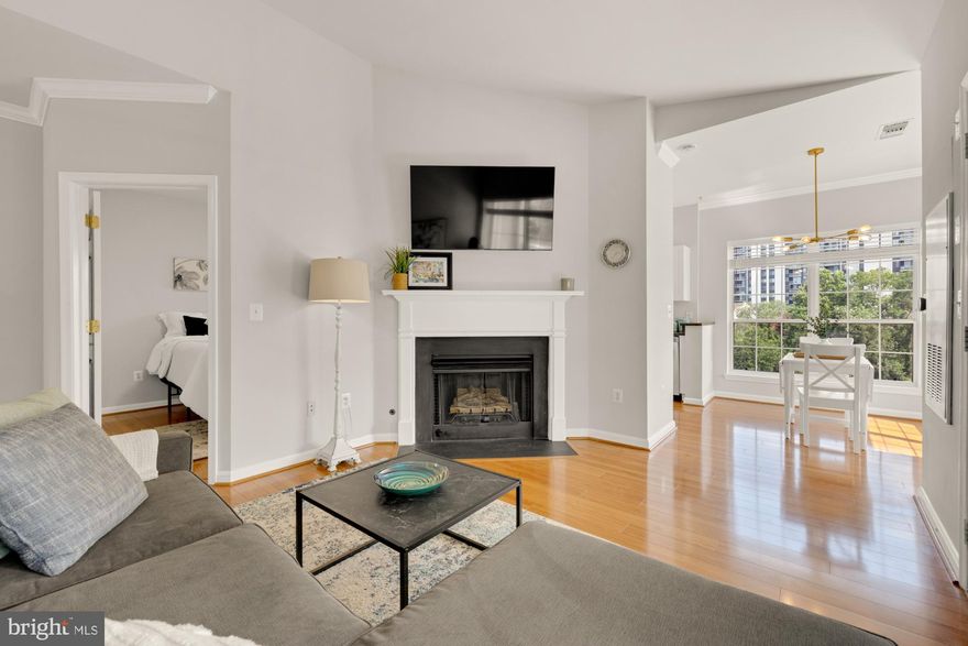 Welcome to Unit 2405, the serene penthouse you’ve been waiting for! Perched on the top floor, this stunning 2-bedroom, 1-bath corner unit offers unparalleled privacy, vaulted ceilings, statement fireplace, abundant natural light, and sweeping views of the peaceful woodlands. With a bright, unique, open-concept layout, 2 private covered balconies, soaring tall ceilings, in unit washer/dryer and assigned garage parking space this penthouse is one of a kind. What makes this unit stand out? This meticulously maintained condo features newly installed granite countertops, gleaming hardwood floors throughout, fresh neutral paint, new cordless blinds, and upgraded smart thermostat. The beautifully designed kitchen, sunlit corner dining area with floor-to-ceiling windows, expansive living room, and statement balcony all connect effortlessly for a cohesive layout.  A full-sized side-by-side washer and dryer are conveniently located in-unit. The spacious main bedroom offers a large walk-in closet and a spa-inspired en-suite bath, while the second bedroom is equally spacious and connects to its own private balcony. This condo offers impeccable privacy with no neighbors above you, never worry about noisy neighbors again. Dryer (2024) HVAC (2018) and Water Heater (2017) What makes this community stand out? Enjoy the convenience of fantastic amenities including ample visitor parking, a 24-hour fitness center, outdoor pool, clubhouse, meeting room, and a peaceful garden with a gazebo. The pet-friendly building allows up to two pets per unit and offers below-average condo fees ($479 /month) covering water, sewer, and trash. What makes this location stand out? Ideally situated on the Arlington/Alexandria line, just off I-395 at King Street, The Palazzo offers unbeatable access to DC, the Pentagon, Amazon HQ2, Old Town, Shirlington, Reagan National Airport, shopping, dining, parks, trails, and more. Welcome home!