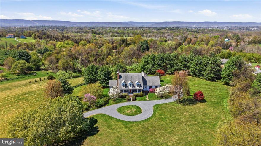 Set on 10 private acres in Lovettsville, this custom-built home boasts 4,300+ finished sqft and was intentionally designed to capture mountain views from every window—where architecture and setting come together to offer space, flexibility, and true main-level living, without an HOA.

A classic exterior with a welcoming front porch opens to a light-filled interior. The main level features a primary suite with an updated full bath and a dedicated laundry room—allowing for true one-level living. The kitchen opens to an informal dining area and family room, extending into a sunroom, while a separate living room and formal dining room offer additional space for entertaining. Beautiful oak wood floors run throughout the main level.

Upstairs features three bedrooms and two full baths, plus a fourth room currently used as a spacious playroom—offering flexibility to serve as an additional bedroom.

The lower level expands the home’s functionality even further. With a private entrance separate from the main basement access, a bedroom and full bath create an ideal setup for a home office, guest suite, or private workspace—enhancing flexibility beyond the home’s four-bedroom septic designation. The lower level also includes a dry bar with cabinetry, counterspace, and a refrigerator. Extensive unfinished space provides abundant storage or future expansion potential.

A spacious fenced backyard provides outdoor living and recreation space, with a separate shed positioned outside the fenced area for additional storage. The home also includes a whole-house generator and a professionally installed lightning protection system.

Surrounded by open land and mature landscaping, the setting is peaceful and private, yet still within easy reach of Northern Virginia’s key commuting routes and amenities—just 5 miles from the Point of Rocks MARC train station, serving the Brunswick Line to Washington, D.C.

Opportunities like this are increasingly difficult to find—offering acreage, mountain views, privacy, and a move-in ready home in one of Loudoun County’s most sought-after rural settings.

SEE DOCUMENTS FOR COMPLETE LIST OF UPDATES:  2026: New Basement Carpet, Painted Powder Room & Installed New Vanity, Replaced Garage Door Springs/Pulleys, New Furnace Humidifier;  2025: Driveway graded & resurfaced with new gravel, Painted Upstairs Bathrooms;  2024: New Washing Machine, New Dishwasher, Painted Primary Bedroom & Bath, New Carpet Upstairs Playroom, New Water Softener System;  2023: New Hot Water Heater, New Sump Pump, Installed Certified Lightning Protection;  2021: Renovated Primary Bath, Painted Foyer, Hallways, Living Room, Kitchen;  2019: Replaced Gutters & Downspouts;  2018: Replaced Furnace;  2011: Replaced Both Indoor Air Handlers &  Outdoor Heat Pumps