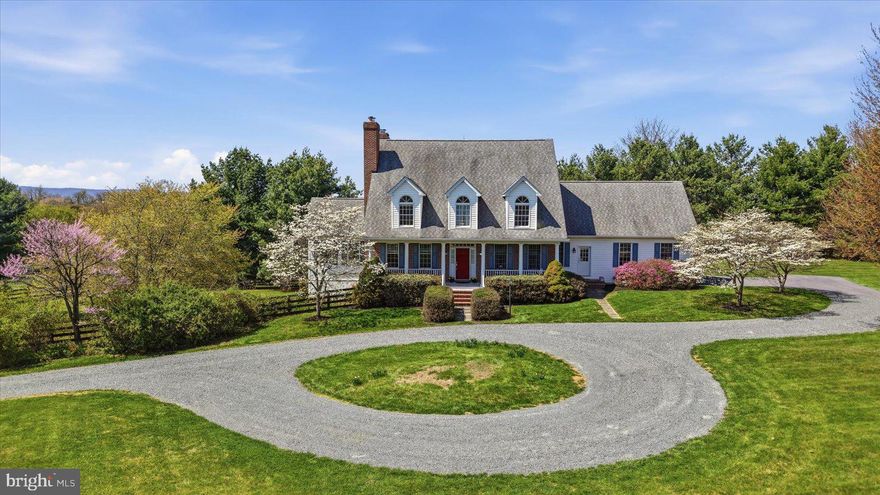 Set on 10 private acres in Lovettsville, this custom-built home was intentionally designed to capture mountain views from every window—where architecture and setting come together to offer space, flexibility, and true main-level living, without an HOA.

A classic exterior with a welcoming front porch opens to a light-filled interior. The main level features a primary suite with an updated full bath and a dedicated laundry room—allowing for true one-level living. The kitchen opens to an informal dining area and family room, extending into a sunroom, while a separate living room and formal dining room offer additional space for entertaining. Beautiful oak wood floors run throughout the main level.

Upstairs features three bedrooms and two full baths, plus a fourth room currently used as a spacious playroom—offering flexibility to serve as an additional bedroom.

The lower level expands the home’s functionality even further. With a private entrance separate from the main basement access, a bedroom and full bath create an ideal setup for a home office, guest suite, or private workspace—enhancing flexibility beyond the home’s four-bedroom septic designation. The lower level also includes a dry bar with cabinetry, counterspace, and a refrigerator. Extensive unfinished space provides abundant storage or future expansion potential.

A spacious fenced backyard provides outdoor living and recreation space, with a separate shed positioned outside the fenced area for additional storage. The home also includes a whole-house generator and a professionally installed lightning protection system.

Surrounded by open land and mature landscaping, the setting is peaceful and private, yet still within easy reach of Northern Virginia’s key commuting routes and amenities—just 5 miles from the Point of Rocks MARC train station, serving the Brunswick Line to Washington, D.C.

Opportunities like this are increasingly difficult to find—offering acreage, mountain views, privacy, and a move-in ready home in one of Loudoun County’s most sought-after rural settings.

See Documents for list of updates.