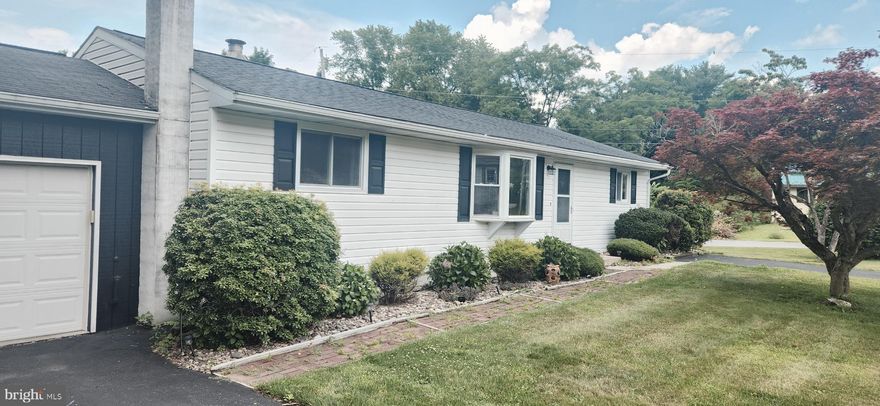 Located in a quiet, well-established neighborhood, this ranch-style home offers a practical layout with 4 bedrooms and 3 full bathrooms. Set on a corner lot, the home features original hardwood floors, an updated kitchen, and a first-floor primary bedroom with an en-suite bath. A spacious addition with vaulted ceilings and a separate entrance provides flexible space—ideal for a family room, home office, or guest area. Step outside to a private deck, perfect for relaxing or entertaining. The home also includes a 2-car garage along with extra off-street parking. The finished lower level adds valuable living space with a comfortable area for gatherings, plus walkout stairs for easy access to the backyard. Conveniently located less than a mile from Ferguson Township Elementary and just over six miles from downtown, this home blends comfort, space, and convenience.