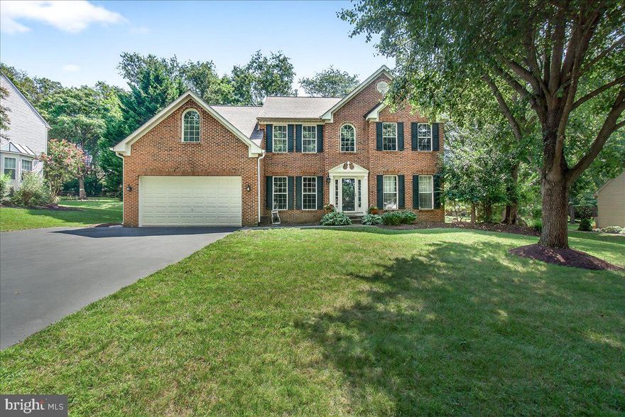 *Offers due Monday 8/4 at 5PM* Stately brick-front Colonial nestled in the highly sought-after Goshen Oaks community, featuring classic navy blue and warm cream accents that beautifully complement the home's timeless curb appeal. A welcoming slate walkway guides you to the front door. The tree-lined backyard is a true retreat, complete with a spacious deck, stamped concrete patio, and thoughtfully designed landscaping. Inside, a soaring two-story foyer greets you with fresh neutral paint and newer hardwood plank flooring that flows throughout the main level. To the left, a versatile room with French doors and glass panels makes for the perfect office, library, or playroom - providing privacy while still allowing visibility to the front entry. To the right is a cozy living space that can be used as a formal sitting room, or whatever suits your lifestyle. Crown molding continues from the living room into the formal dining room, which is finished with elegant chair rail detailing. The beautifully updated powder room features stylish board and batten trim and is conveniently located between the foyer and kitchen. The kitchen itself has been modernized with granite countertops, crisp white cabinetry, stainless steel appliances, and a standout island with navy blue base cabinets and a butcher block countertop. A built-in desk nook provides the perfect space for homework or planning the week ahead. Large windows with transoms and a door to the deck flood the space with natural light. The adjacent sunken family room is full of character, featuring a modern shiplap accent wall and gas fireplace for cozy evenings at home. Off the kitchen, a practical mudroom with built-in hooks and shelving helps keep things tidy as you come in from the garage. Step outside to enjoy the serene backyard from the large deck or lower patio, the deck can be shaded by a retractable awning .Upstairs, the primary suite is a true sanctuary. A vaulted ceiling adds a sense of space, while the fully renovated en suite bathroom brings spa vibes with a freestanding soaking tub, a luxurious Roman shower with rustic tile, dual vanities with ample storage, a private water closet with a pocket door, and a spacious walk-in closet. Four additional bedrooms offer flexibility for guests, family, or storage needs. Two of the bedrooms feature easy-care laminate flooring, including one with an upstairs laundry setup added by a previous owner (which could be converted back to a closet if preferred). The remaining bedrooms have plush carpet for comfort and noise reduction. An updated hall bathroom rounds out the upper level. The finished lower level provides even more flexible living space; ideal for a teen lounge, playroom, gym, or media area. A custom stained wood shiplap accent wall adds warmth, and soft carpeting makes the space inviting for kids and guests alike. A full bathroom is available on this level and an additional finished room with laminate flooring and a closet could serve as an additional office, or hobby room. There’s rough-in plumbing ready for a future wet bar. Walk-up stairs lead directly to the backyard for easy access. Additional highlights include a two-car garage, extended driveway, extra parking pad and small shed for added convenience. The HVAC and heat pump were replaced in 2022, and the roof was replaced in 2017, offering added peace of mind for the next owner. Nearby Magruder Branch Stream Trail and Damascus Regional Park offers playgrounds, basketball courts, walking paths, and streams; the wildlife and woodlands are absolutely captivating. Restaurants and shopping stores located in Damascus, Mount Airy, and Germantown are in close proximity. With so many scenic backroads connecting to Damascus, commuting to Frederick, Rockville or DC has many options. MARC train station is in Germantown about 8 miles away, while the Shady Grove metro is about 15 miles away.
