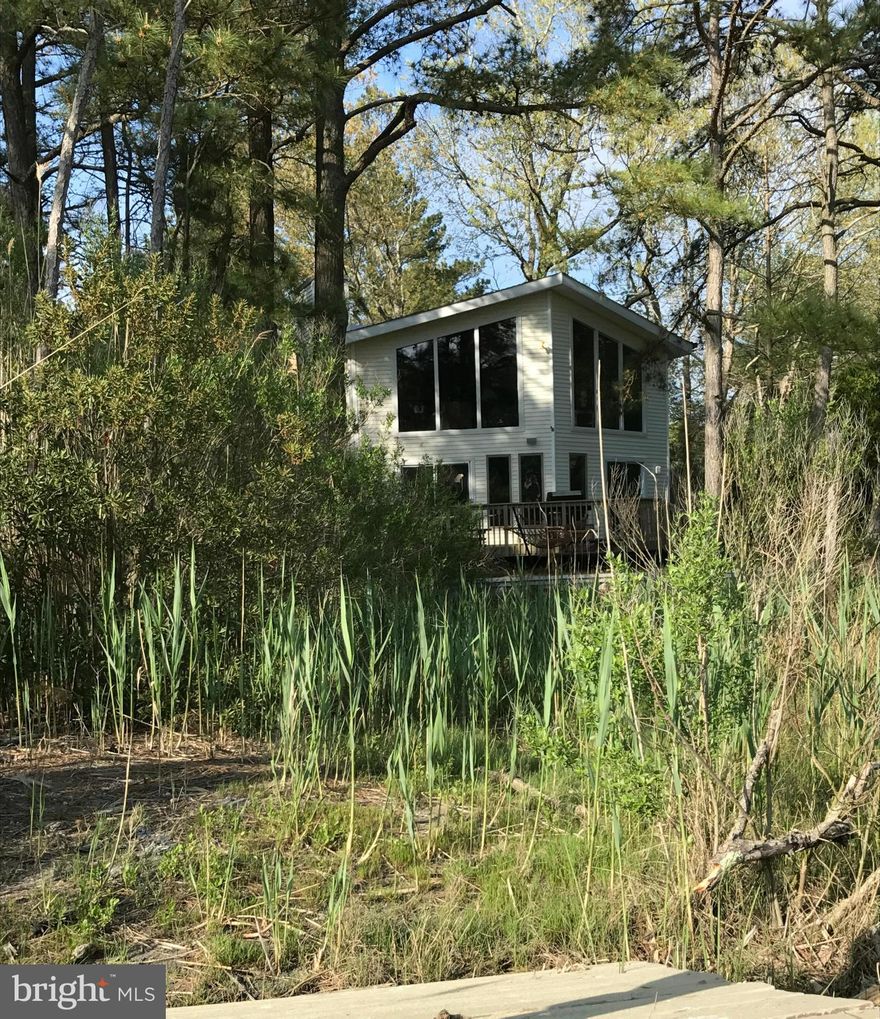 Waterfront beach retreat nestled in the pines - perfect spot to unwind w/ fun for everyone. Appreciate the tranquil views of Manklin Creek. Fish, crab, or launch your kayak from the private pier. Enjoy all the amenities Ocean Pines has to offer! Home has spacious floor plan w/ picture windows, all new flooring, fresh paint & 2 fireplaces for year-round comfort. Amazing location! 7 miles to OC.