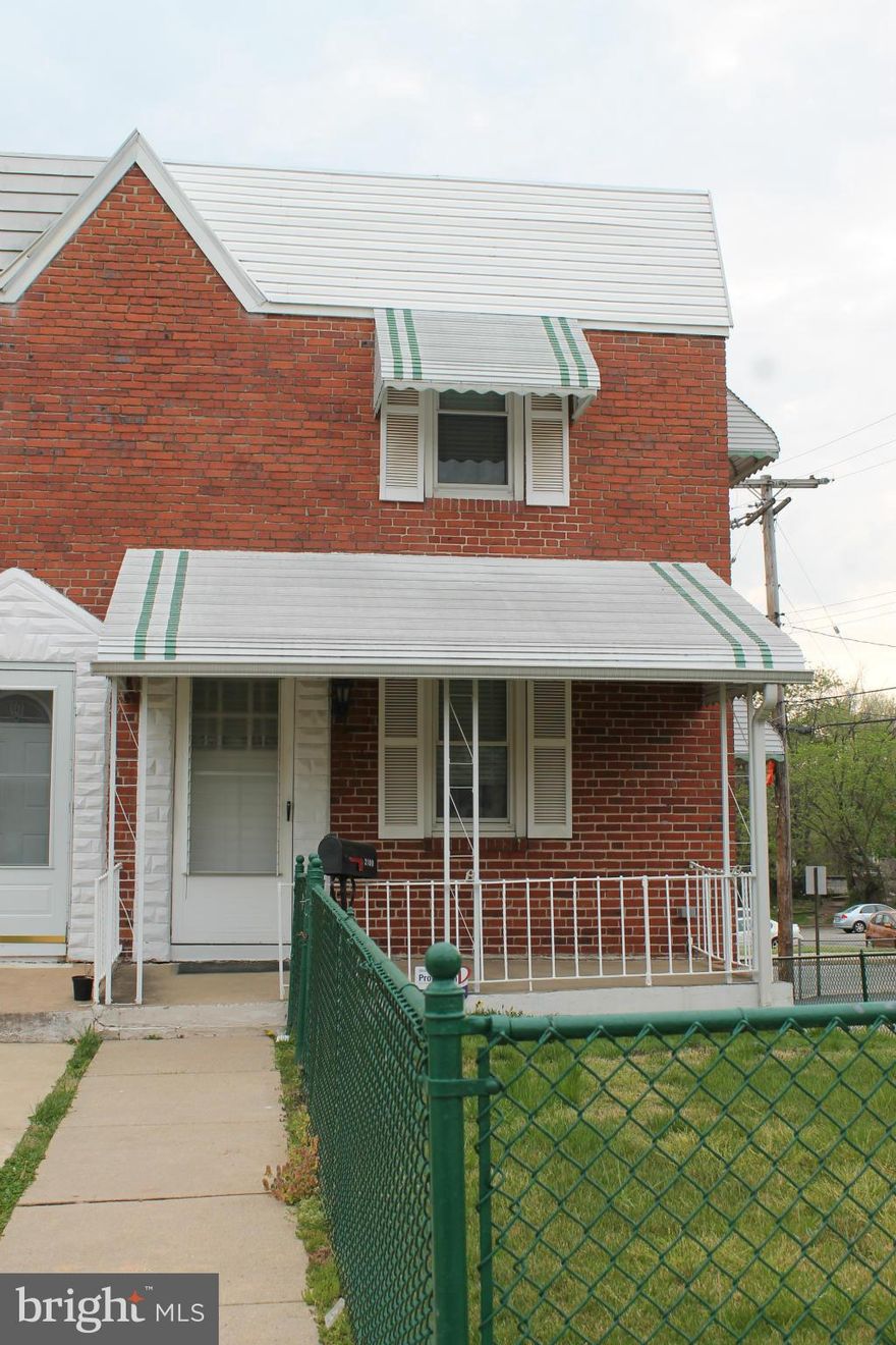 End of group, corner lot row house. Complete with parking pad and large fenced yard. Located on quiet street, house backs to school. Great opportunity for a first time home buyer. Well cared for by long time owners. Newer windows, hardwood under carpet. Add your finishing touches to make it home.