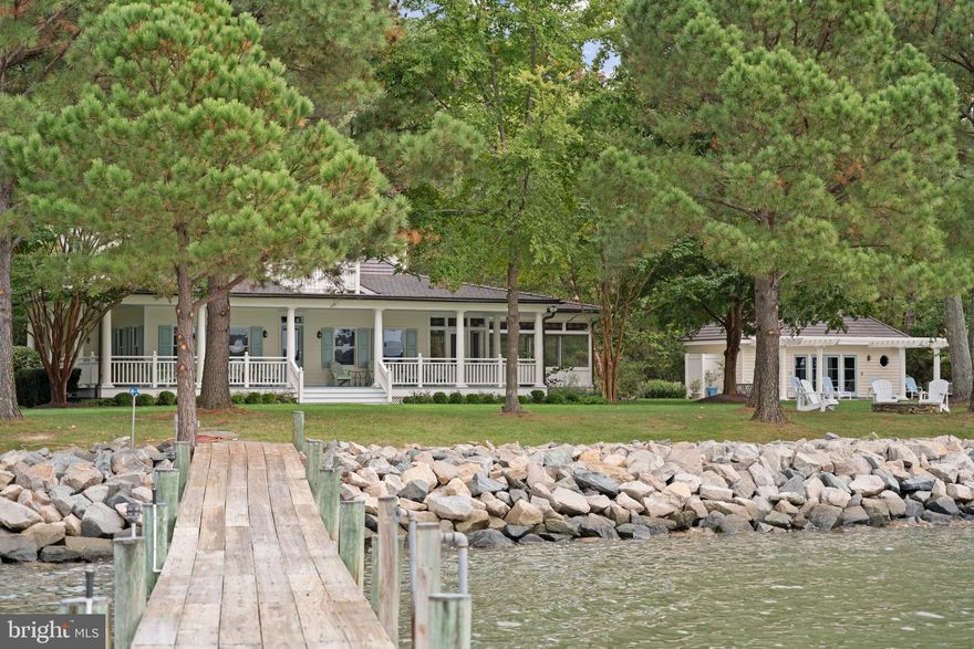 Welcome to this private paradise on Maryland's Eastern Shore with a slip for two boats. Ideal for outdoor enthusiasts, with 1400' of views oriented towards the water. The residence features an open floor plan with a spacious living and separate dining area with a fireplace, leading to the gourmet kitchen. The main floor also offers two bedrooms and a full bathroom. Upstairs is a primary bedroom suite with laundry, and exquisite waterfront views. Not to mention, the sunset views over hundreds of feet of water from the large wrap-around porch.

Amenities abound on this property. There is geothermal heating and air-conditioning, plus a sprinkler system. The home offers a completely sealed and temperature-controlled basement with poured concrete flooring ideal for storage. There's a two bedroom guest house with full kitchen and living room. An oversized saltwater swimming pool with pool house (with bath and outdoor shower) is adjacent to the house and overlooks Grace Creek. The living shoreline has rip rap bulkhead and is stable without prior erosion. A sport court provides further outdoor enjoyment nestled between the trees. On colder days, gather round the fire pit and watch the sun set over the water. Or, rest in the hammock overlooking the dock. Park your boat on the private slip. Or, relax on the wide porch and watch other boats pass by. Anyone wanting to enjoy waterfront life will be in paradise in this custom-built home on a scenic 5.89 acre lot.