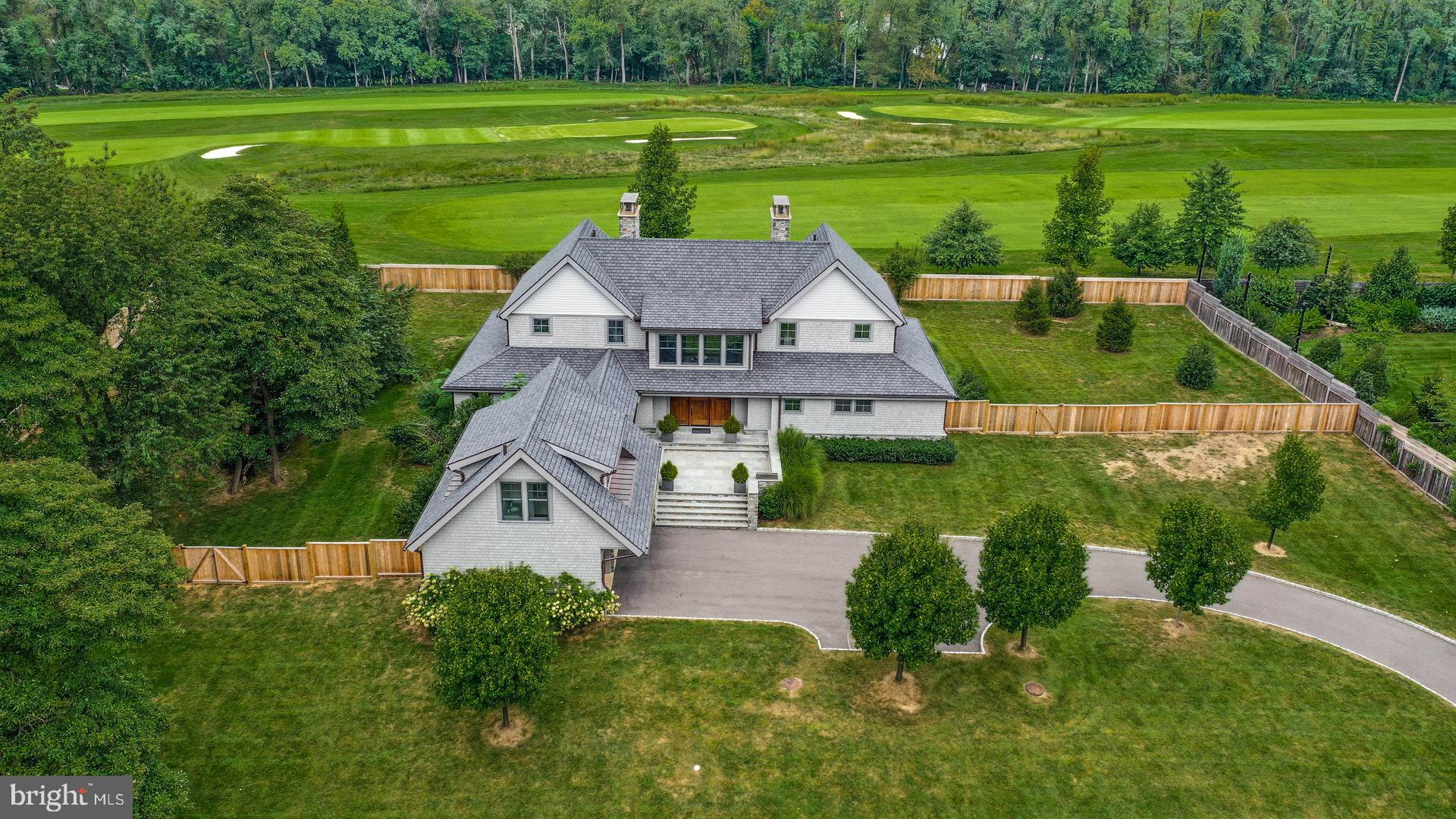 Absolute Perfection! Nestled on one acre of pristine, private grounds abutting the Philadelphia Cricket Club's Saint Martin's golf course, this exquisite residence is a seamless blend of traditional & contemporary spaces and offers state-of-the-art highest quality finishes throughout. Light-filled, open and airy, this ideal sized residence is better than brand new and offers an excellent floor plan for today's modern living. Enter through the handsome mahogany front door into the foyer area with coat closets, powder room and oak flooring throughout. The spectacular two story living room is breathtaking with a wall of windows and Kingsman two -sided gas fireplace. The adjacent open space includes a family & dining room combination with built-in cabinetry and wet bar. French doors lead to a covered porch that offers a great spot for entertaining or just relaxing after a busy day. The ultramodern eat-in kitchen includes Poggenpohl cabinetry, marble backsplash & countertops, Wolf range, hood & microwave drawer, Bosch dishwasher and SubZero refrigerator. The superb design offers a built-in desk, breakfast bar and large pantry closet. Off of the kitchen is the mud room/laundry area with Whirlpool washer & dryer, built-in bench and garden sink. Looking for a first floor bedroom? This is as good as it gets! This main bedroom en suite offers a bathroom with large marble steam shower, hydrosystem tub, radiant heated floor and double vanities. Includes a customized walk-in California closet, gas fireplace and French doors leading to an inviting covered porch. Upstairs there is a large open space which can be used as a sitting room and/or office with spectacular views of the surrounding grounds. On either end of the second floor, there is en suite bedroom each with a gas fireplace, marble bathroom, large closet and private balcony. The fourth bedroom en suite is situated off of the kitchen over the garage.. If so desired this space would make an excellent in-law suite or au pair quarters. The lower level is beautifully finished! Includes a large open space with oak wood flooring, a recreation area, kitchenette with Poggenpohl cabinets, marble countertops & backsplash, SubZero refrigerator drawers & ice maker. There is a wine cellar with Millesmine racks & tech lighting and a great place for wine tasting with friends. You will find three large storage closets on the way to the exercise room which includes a wall of mirrors and LockTough rubber tile flooring. Opposite the gym is a full marble bathroom. Don't miss the movie theater with screen, projector and World Wide Stereo equipment included. There is a utility/storage room on either side of the lower level and an exit to the outside. The attractive exterior includes Maibec 200 cedar shingles, step lighting, Hubberton Forge sconces, an attached two car garage with a courtyard offering plenty of additional parking. Includes privacy fencing around the side & rear yards. City of Philadelphia Tax Abatement in place until 10/2028. While this premier location is quiet and secluded, it is so convenient to the quaint shops & many eateries along Germantown Avenue plus all the other numerous amenities the village of Chestnut Hill offers. Enjoy the proximity of the Wissahickon Valley with hiking and horseback riding trails just footsteps away from your front door. Walk to the local train lines for a quick ride into Center City or connect with Amtrak for a stress free commute to NYC. Experience the perfect combination of cosmopolitan and suburban living right here in the city! Hurry and schedule your private showing today.