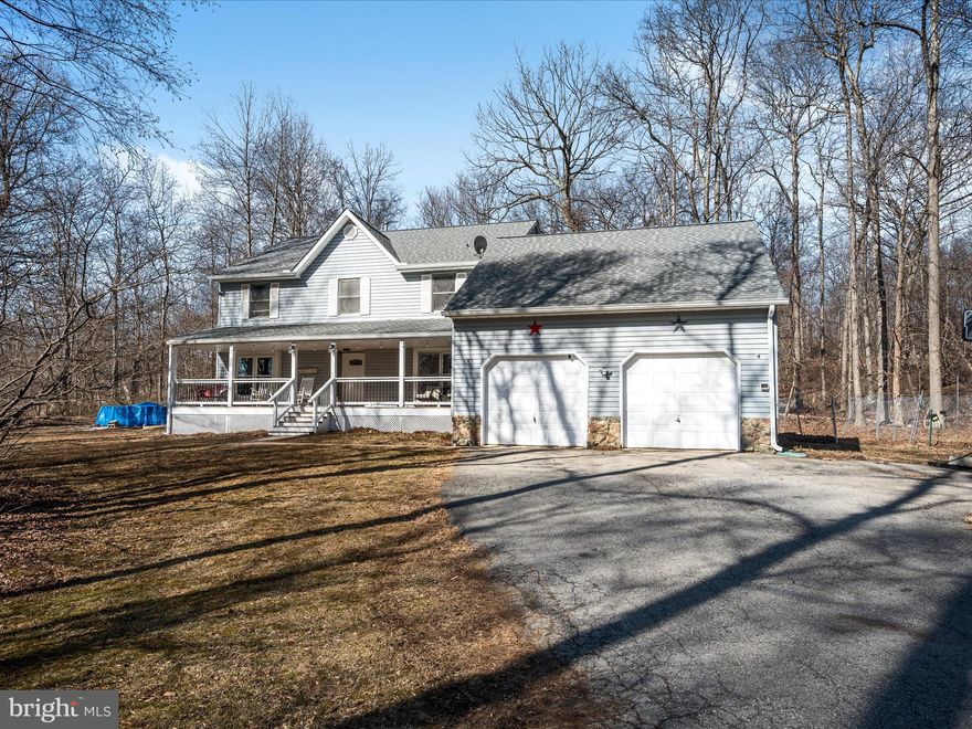 Nestled on over five picturesque, wooded acres, this beautiful two-story traditional home exudes charm and character. A spacious country front porch welcomes you, setting the stage for the inviting atmosphere found throughout the home. Inside, an open floor plan creates a seamless flow, with generously sized rooms that make both everyday living and entertaining effortless. The distinctive hardwood floors add warmth and timeless appeal. At the heart of the home, the well-appointed kitchen features granite countertops, a large island with barstool seating, and brand-new oven and microwave. A new bay window floods the kitchen space with natural light, making it a bright and inviting gathering place. The living room boasts a striking stone gas fireplace, perfect for cozy evenings. Designed for versatility and comfort, the home includes a main-level bedroom and full bathroom, ideal for guests or a home office. Upstairs, the primary suite and two additional bedrooms offer privacy and relaxation. The bonus room over the garage is an expansive finished space, providing endless possibilities for a recreation room, home theater, or additional living area. This home has been thoughtfully updated, including new main-level windows (2024), fresh interior paint, and modernized lighting throughout. The primary and hall bathrooms feature new vanities, and the room above the garage was updated with new carpet and paint in 2023. Additional upgrades include a newer roof (2020), newer HVAC system (2022), new tankless water heater, and an updated wood stove. For added peace of mind, a backup generator ensures reliability. Outdoor living is just as appealing, with a spacious composite deck overlooking the private backyard—perfect for entertaining or enjoying the serene surroundings. A new firepit invites cozy gatherings, while a brand-new chicken coop offers the opportunity for hobby farming. Best of all, with no HOA, you have the freedom to enjoy the property as you see fit. Additional features include a full unfinished basement with walk-up stairs to grade level, providing endless possibilities for storage, a workshop, or future expansion. The oversized garage offers ample storage space for vehicles, tools, and outdoor equipment. Conveniently located just 5 miles from Route 15, this home provides easy access to major roadways while maintaining a peaceful, private setting. Nearby Cunningham Falls State Park offers hiking, fishing, and endless outdoor recreation. Don’t miss this incredible opportunity—schedule your private tour today and experience the charm and comfort of this exceptional home firsthand!