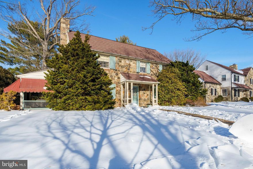 This 4-bedroom stone home in Alapocas has retained all of its original charm and character, providing a fantastic opportunity for the new owner to honor certain features while making updates to meet today’s functionality and style.  Built in 1954, and owned by the same family since then, the spacious floor plan was designed for comfort, sophistication and entertaining.  The covered front entrance has a built-in bench on one side which is typical of many of the homes in this coveted, picturesque neighborhood.  Step inside and you are welcomed into the foyer of this classic Colonial where you will notice the random width, pegged hardwood floors which continue throughout the home.  The large formal living room on the left has handsome millwork including crown molding, chair rail, and a wood-burning fireplace is the focal point with elegant dentil molding.  From here you can access the enclosed screened porch; a lovely seasonal extension of your living or entertaining space!  The dining room is on the other side of the entryway and it has a beautiful built-in corner cabinet to store and display your favorite pieces.  The kitchen is a step back in time with the original cabinets, a cast iron sink with drainboard, and a vintage oven!!  But the best part is right around the corner…an adorable breakfast booth with a great retro vibe is the perfect spot to enjoy your morning coffee!  A powder room and a wood-paneled den complete this level.  Upstairs, there are four bedrooms; the largest of which is the Primary Bedroom with an en-suite bathroom.  The other three bedrooms share a full bathroom conveniently located at the top of the stairs.  The attic can be accessed via pull-down stairs, and is surprisingly large.  A turned garage supports your parking and storage needs, and is positioned in such a way so that you can navigate coming and going from the driveway with ease.  An entrance to the kitchen from the back side of the house here is functional and convenient.  There is also a stone patio and lots of yard to enjoy!  Now is the perfect time to purchase a home in Alapocas that you can make completely your own!  Located on a quiet street just a few blocks from Wilmington Friends School, and within walking distance to trails, this home is waiting for a Buyer who is ready and willing to take on renovations.  To help buyers envision the potential of this home, the listing contains exterior and interior renovation concepts; images were generated using AI.