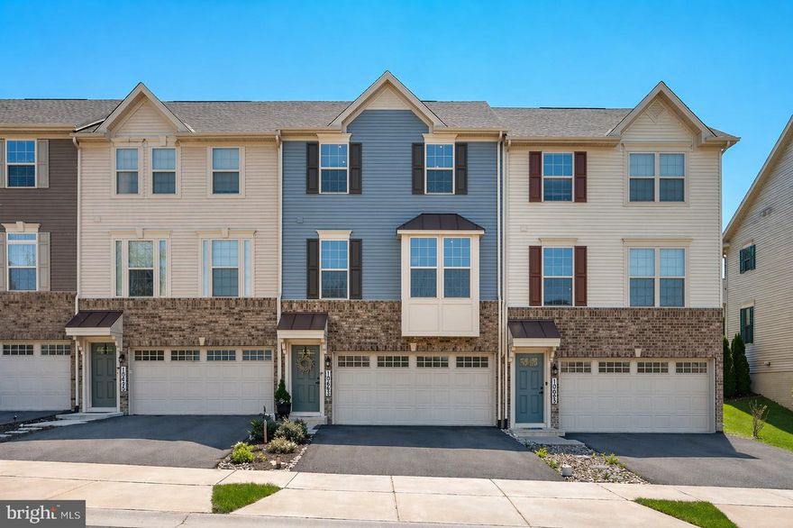 Location this good does not come up often. Neither does everything else this home brings to the table.

Built in 2021 and thoughtfully upgraded since, this townhome in the Hamptons at Lake Linganore has been transformed into something you rarely find on the market. The owners replaced builder-grade finishes with rich LVP flooring, added custom wood accent features throughout, and brought a level of warmth and intention to the space that makes it feel less like a townhome and more like a boutique retreat you get to come home to every day.

The kitchen features a large island with seating for four, upgraded Samsung stainless appliances, and granite countertops. The sun-filled dining area flows naturally from the kitchen and opens to a deck with stairs down to the backyard, making indoor to outdoor living genuinely easy. A powder room rounds out the main level.

Upstairs, the owner's suite features a tray ceiling, recessed lighting, a double bowl vanity, a walk-in shower, and a walk-in closet that delivers on space. Two additional generously sized bedrooms, a full bathroom, and laundry room complete the upper level. The finished lower level is ideally laid out for a gym and media room, giving you two functional spaces without sacrificing either.

What sets this home apart from everything else in the neighborhood is its location directly across from Blue Heron Elementary School. You can see it from your front door. That kind of proximity is rare, and once you have it, you will not want to give it up.

The Hamptons in Lake Linganore delivers on amenities in a way few communities can match. Four lakes, three beaches, four swimming pools, 35-plus miles of trails, pickleball, tennis, volleyball, tot lots, and a consistent calendar of community events (Food Truck Tuesdays, Fall Festivals, and more) make this a neighborhood people genuinely invest in staying.

Additonal upgrades the sellers have completed include upgraded insulation in the attic for optimal efficiency. 
If you want a move-in ready home with real upgrades, a layout that works, and a location that makes daily life easier, this is the one. Schedule your showing today.