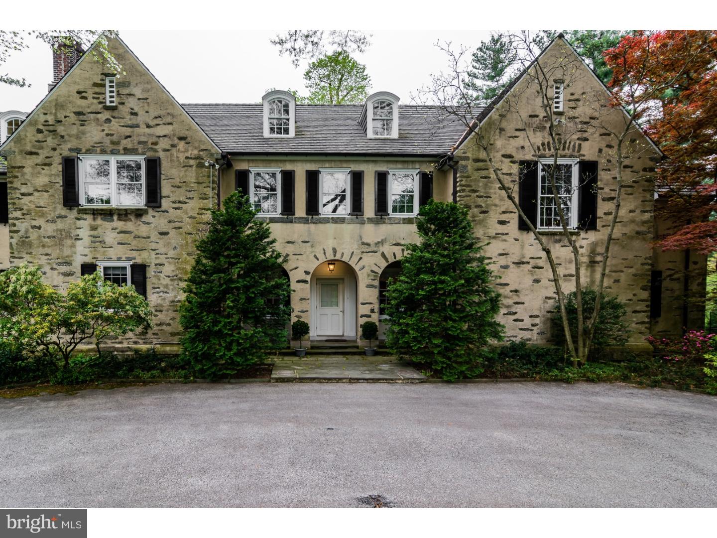 We are extremely proud to offer 6910 Wissahickon Avenue, a truly spectacular property; originally a Tudor Revival designed by Charles Barton Keen in 1911, it underwent an extensive renovation by noted architect Sydney Martin in 1930. Feast your eyes on this magnificent residence with handsome Ludowici tile roof beautifully sited on 3.5 acres. The first floor features a brightly lit, gracious floor plan with coveted architectural details and moldings, meticulously and lovingly maintained. Large entry hall with dramatic spiral staircase, formal living room elegantly appointed with Gracie wallpaper, large formal dining room with fireplace, handsome wood paneled library and sunroom. Fabulous Smallbone gourmet kitchen with all the bells and whistles and adjacent family room. Sunroom opening onto a large flagstone and brick terrace. Upstairs, in addition to a gorgeous master suite with a fireplace and terrace, two floors of family bedrooms, baths, offices and comfortable living spaces. Lower level offers additional family room with kitchen opening onto beautiful har-tru tennis court just a few steps from the pool. The coach/carriage house with 5 bays, and large, well appointed two-bedroom, two bath apartment above completes the picture, creating an extremely private setting, a short drive to Center City or the village of Chestnut Hill, and the Wissahickon trails. It simply doesn't get any better than this!