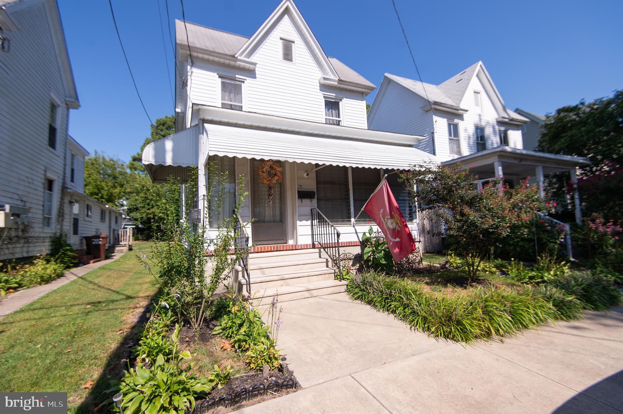 Welcome to 211 Choptank Avenue, nestled in the heart of Cambridge’s Historic West End on a street brimming with charm. A welcoming front porch sets the tone — the ideal spot to enjoy morning coffee, take in views of the Choptank River, or simply sit back and relax. The porch also adds comfort and efficiency, helping regulate the home’s climate and serving as a buffer from the elements. Inside, the home offers a traditional, functional floor plan beginning with a spacious living room, abundant storage, and an auxiliary dining area. The large kitchen provides generous counter and cabinet space, there's even the ability to add a wall oven with hookup in place for anyone who wishes to install. The laundry area houses a surprise- behind the adjacent cabinet doors you'll find a built-in drying rack, shelving, and even pull-out hamper. A full bath completes the first floor. Upstairs, you’ll find a spacious primary bedroom, two additional bedrooms, each with ample closet space, and a large bathroom with double vanity, walk-in shower, and jetted tub. Another plus for this home is the mudroom with rear exterior access and a private, low-maintenance fenced yard. The expansive concrete pad is perfect for entertaining, with hookups in place for a pool/hot tub. A detached garage offers side-entry overhead door, work benches, loft, and even a sauna (as-is) — ideal as a hobby space or “he/she shed.” Rear alley access creates the opportunity for off-street parking with simple modifications. All this within walking distance of the farmers market, yacht basin, boat ramp, parks, and downtown shopping and dining. Enjoy easy drives or day trips across the Shore & Delmarva or even venture to the city — approximately one hour from Ocean City to the east and Annapolis to the west. *Sellers need the ability to select a replacement property, if preparing or submitting an offer please prepare accordingly*