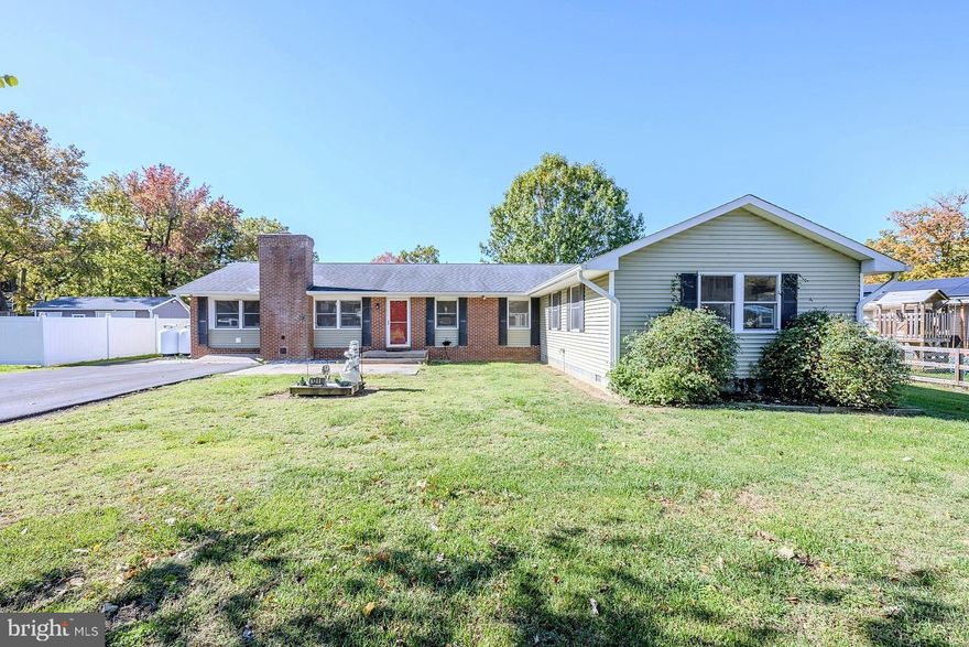 Welcome to this spacious rambler in the sought-after Ramsey Bay community! This 4-bedroom, 2.5-bath home offers an inviting open layout and plenty of upgrades throughout. As you enter, you’re greeted by a large open living room featuring a floor to ceiling brick fireplace with a pellet stove and durable laminate wide plank flooring that flows through the main living areas. The open-concept design connects seamlessly to the dining area, complete with built-ins and a bar with beverage fridge, perfect for entertaining. The oversized kitchen includes an island, abundant cabinet space, dual smooth top ranges, a built-in microwave, a large refrigerator, freezer, and dishwasher. Off the kitchen, you’ll find a convenient laundry room and an all-season sunroom with soaring cathedral ceiling and walls of windows filled with natural light. Step outside to enjoy two separate decks—one on each side of the home—plus an outdoor fully equipped kitchen, ideal for gatherings and cookouts. The property features a generous yard with two storage sheds and a newly paved driveway. The bedroom wing offers four spacious rooms, including one with a private half bath. The hall bath features a full-size shower, while the primary suite impresses with an oversized layout, walk-in closet, ensuite bath, and even a private sauna. Additional highlights include a Generac generator, access to nearby water and pier privileges, and a location within a top-rated Blue Ribbon school district. The community also offers a playground and a pier at the end of the block—perfect for enjoying the water and sunsets. Escape to a relaxing lifestyle by the water in beautiful Ramsey Bay!