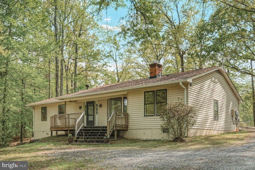 Enjoy peace and tranquility with country living on massive treed approximate 5.80 acre lot, yet within easy commute to stores and restaurants.  Easy one-level living with ceiling fans galore, updated kitchen with stainless appliances, induction cooktop, 42" cabinets, built-in microwave and wall oven, remodeled baths, and Energy Star front door circa 2022.  Tons of parking.  Leonard shed with workshop, small barn with lawn mower storage.  3 bedrooms, office adjacent to kitchen, and family room with full bath off dining room.