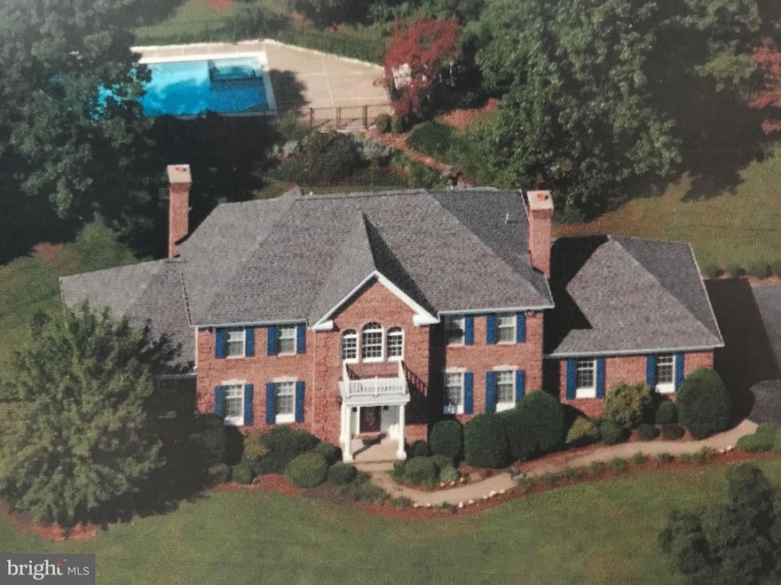 All brick home offering 2 story foyer, HWD floors, step-down family room, enormous library, large kitchen, Master BR suite with fireplace, walk-in closet  & spacious bath, possible in-law/nanny suite on Main level, finished L/L with kitchenette Plus an in-ground pool.  Imagination Is what it takes!  5 bedroom 4 Bath home that needs some  Tender Loving Care  .  The  wonderful location and pretty grounds will make up for any minor problem.  Quiet Street.