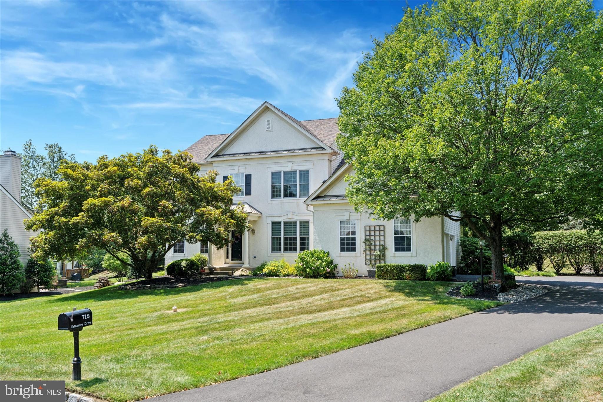 Welcome to this gorgeous home on a premium lot backing to the 5th fairway at Talamore Country Club. A dramatic two-story foyer welcomes you to this meticulously maintained home that offers an open floorplan ideal for everyday living and elegant entertaining. Just off the foyer, you’ll find an office with a double door entryway and handsome built-ins, offering a quiet space for work or relaxation. The living room and dining room exude sophistication with chair rail and crown molding. The heart of the home lies in the island kitchen featuring abundant white cabinetry, hardwood floors, granite counters, black composite sink, ceramic tile backsplash, pantry and built-in desk area. The bright and airy breakfast room has a brand-new Andersen sliding door to the exterior, hardwood floors and gorgeous windows that essentially bring the outside in. Sensational two-story family room with a stunning stone gas fireplace, a wall of windows, built-ins and hardwood floors. A convenient laundry room and powder room complete the main floor. Recharge after a long day in the primary bedroom retreat where you can enjoy the serenity of your private deck enhanced by a newer Andersen sliding door and a retractable awning. Or, relax in your luxurious bath complete with a jetted tub, ceramic tile and dual bowl vanity. The walk-in closet will meet your wardrobe needs while a second closet will come in handy for seasonal storage or sharing. Three additional generously sized bedrooms, one currently being used as an amazing dressing room that easily converts back to a regular bedroom, a spacious hall bath and a linen closet round out the second floor. More living space and a full bath await in the finished basement. There is storage in the unfinished section as well as a workshop area. Head outside to host summer events and gatherings in a very peaceful and tranquil setting on the paver patio This outdoor space has a secluded and private feel thanks to mature trees and retractable awnings that protect you and your guests from the elements. Additional property assets include a new roof in 2019, oversized two-car attached garage, custom window treatments and blinds, recessed lighting, security system, neutral décor and beautiful plantings and landscaping. Embrace an active lifestyle with access to six complimentary rounds of golf on the highly-ranked golf course, a short game center, tennis courts, a fitness center, a swimming pool, and dining privileges at the Talamore Country Club. Minutes from all kinds of shopping including Whole Foods and Trader Joes, the vibrant town of Ambler, all major arteries and public transportation, this location and community provide an exceptional opportunity.