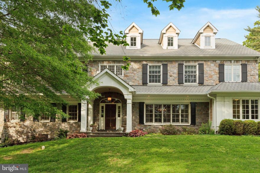 Welcome to 1027 Fairway Lane – A Custom Bradley Brothers Masterpiece in the Heart of Gladwyne.

Nestled on a quiet cul-de-sac in one of the Main Line’s most coveted neighborhoods, this exceptional 5-bedroom, 5 full and 1 half-bath home offers over 6,000 square feet of beautifully appointed living space on nearly an acre of private, flat grounds. Thoughtfully designed and extensively renovated and expanded in 2007, this custom Bradley Brothers-built residence combines timeless elegance with modern comfort, all within the award-winning Lower Merion School District. 

From the moment you arrive, you’ll be captivated by the long, private drive and lush landscaping that frame the home. Step through the front door into a dramatic two-story foyer featuring hardwood floors, an open quarter-turn staircase, and detailed raised panel wainscoting throughout the first floor—just the beginning of the fine millwork and architectural detail found throughout the home. To the left and right of the foyer are a cozy sitting room/formal living space and a light-filled formal dining room ideal for hosting memorable gatherings. The gourmet eat-in kitchen is a chef’s dream, boasting custom cabinetry, granite and quartz countertops, tile backsplash, and top-tier appliances, including an 8-burner Wolf range and paneled Sub-Zero refrigerator. A generous island with prep sink, wine fridge, and seating anchors the space and opens to a spectacular family/great room with vaulted beamed ceilings, a floor-to-ceiling stone gas fireplace, built-ins, wet bar, and oversized windows with built-in seating—plus two sets of French doors leading to a serene flagstone patio. An inviting main floor ensuite bedroom with private bath and patio access offers flexibility for guests or multigenerational living. Additional main-level highlights include a richly appointed office with custom built-ins, an enormous mudroom with cubbies and shelving, and a stylish powder room.

Upstairs, the spacious primary suite impresses with a custom dressing room and spa-like bath featuring a soaking tub, glass-enclosed shower, and dual vanities. Three additional bedrooms—two of which have ensuite baths—a convenient second-floor laundry room, and expansive attic storage complete the upper level.

The fully finished, walk-out lower level is equally impressive, featuring a second family/media room, island countertop w/stools, exercise room, full bath, and abundant storage. Plans for a future pool are available upon request, and the level backyard offers plenty of room to entertain or expand.

Additional standout features include:
• Low taxes for the area
• High-end energy-efficient windows for lower utility bills
• New HVAC system
• Whole-house generator
• Exquisite woodwork, arched doorways, and keystone moldings
• Mature landscaping offering privacy and beauty year-round

Located just minutes from the charming Village of Gladwyne, scenic hiking trails, top-rated schools, and with easy access to I-76 for a quick commute to Center City, this is a rare opportunity to own a truly turn-key custom home in one of the Main Line’s most desirable locations.

Don’t miss your chance to make 1027 Fairway Lane your forever home—schedule your private showing today!