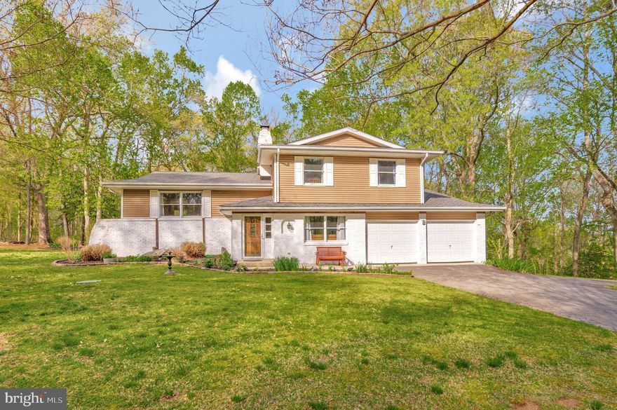 Discover tranquil living at 7780 Simms Landing, where this meticulously updated 4BR/2.5BA split-level home is nestled on a private 2-acre lot in Port Tobacco. Mature crape myrtles and flowering dogwoods create a peaceful sanctuary, with the Port Tobacco River just a 0.5-mile walk away—perfect for morning coffee while enjoying nature or eagle watching. Yes, you can see eagles flying by! The attractive home exterior features distinctive lime-washed brick accents that add unique character and charm, complemented by a new architectural shingle roof installed in April 2025 that ensures worry-free ownership.

Step inside to find a thoughtfully designed open-concept main level, where the recently remodeled kitchen (2021) shines with premium stainless-steel appliances, elegant granite countertops, and custom white cabinetry accented by a stylish glass tile backsplash. The oversized center island with a breakfast bar offers additional prep space and casual seating, perfect for entertaining while enjoying views of the natural landscape.

The inviting library/living room features a cozy wood-burning fireplace situated next to the custom handcrafted bar—which conveys with the home—creating the perfect entertainment space for hosting family and friends on cold days or enjoying quiet evenings with a good book. The dining area flows seamlessly into comfortable living spaces filled with abundant natural light from windows showcasing scenic surroundings.

The well-designed bedroom layout provides privacy and comfort for everyone, with the primary suite serving as a peaceful retreat featuring large windows framing views of the mature trees. The primary bathroom was elegantly remodeled in 2021 with a double vanity featuring stylish fixtures and a modern white subway tile shower with decorative accent strips. Three additional bedrooms offer ample space for family members, guests, or versatile home offices—ideal for those working remotely. The beautifully renovated hall bathroom (2021) completes the upper level with contemporary finishes, including a modern vanity and a fully tiled shower/tub combination.

Nature enthusiasts will cherish the expansive outdoor living spaces surrounding this special home. The large, private backyard features a brand new oversized wood deck (April 2024) perfect for outdoor dining and entertaining, while the firepit area creates a magical setting for evening gatherings under the stars. A hammock hangs between two mature trees, offering a peaceful spot to relax and enjoy the tranquil setting. The property offers scenic paths for nature walks, with the Port Tobacco River accessible just a short distance away. A new shed with electricity (2021) provides additional storage or potential workspace.

Recent improvements ensure maintenance-free living, including a new high-efficiency HVAC system (2024), septic system was pumped in 2024 and a whole-house water filtration system. The versatile lower level provides additional living space with a cozy family room featuring built-in bookshelves, dedicated home office space, and an additional flex area that could function as a gym, media room, or additional sleeping quarters. The convenient two-car garage offers ample parking and storage or your own CrossFit gym.

Enjoy rural charm without sacrificing accessibility—just 8 miles (15-20 minutes) from downtown La Plata, 28 miles (40-60 minutes) from Washington, DC, 28 miles (40-50 minutes) from Alexandria, VA, and 45 miles (55-65 minutes) from BWI Airport. This exceptional property perfectly combines serene living with beautiful Port Tobacco River access and practical accessibility.