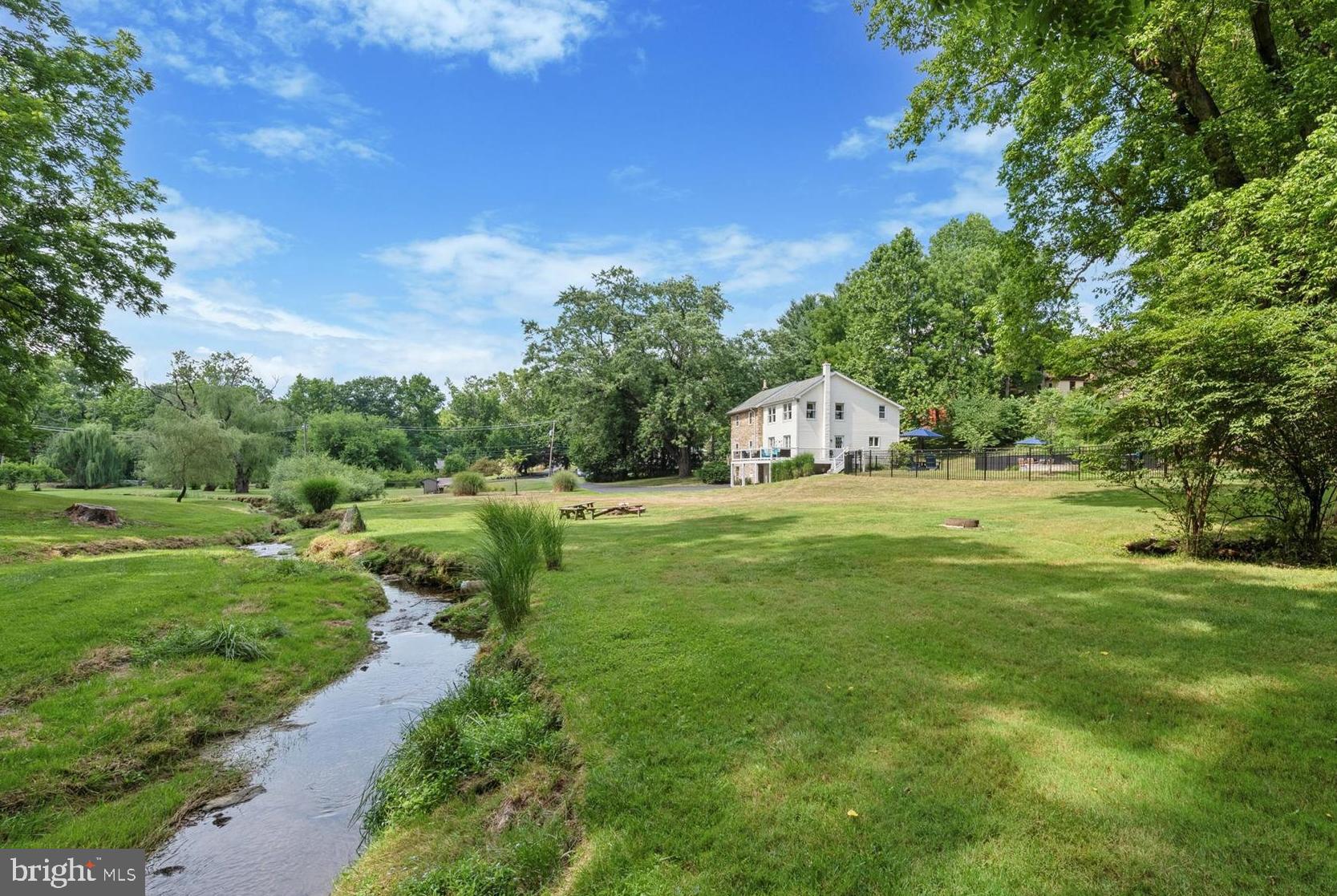 Discover your dream home in Malvern, PA—a stunning 8.1-acre estate with a beautifully updated modern farmhouse. This secluded property offers the perfect blend of tranquility, modern amenities, and accessibility. The original farmhouse structure dates back to an original spring house in 1740, with the house built in 1840 and 1939, and a major addition in 1994. The current owners have thoughtfully updated the home to suit modern sensibilities while retaining its original farmhouse charm, including a full kitchen remodel (2024), updates to all three bathrooms, saltwater pool and spa (2021), HVAC (2019), and roof (2018). The home offers six bedrooms and three bathrooms and boasts hardwood floors throughout. The spacious primary bedroom has an en suite bathroom and a large walk-in closet. The primary bath offers luxurious amenities such as a two-person spa shower with dual rain shower heads, a jetted bubble tub, heated tile floor, and granite countertops. The additional five bedrooms can accommodate a large family and/or provide multiple office spaces for a work-from-home lifestyle. The farmhouse kitchen is equipped with brand new white maple wood cabinets, quartz countertops, 36” glass top electric range, and beverage refrigerator. Outdoors, enjoy a private oasis with a babbling creek, fire pit, wooded areas, and expansive open yard. The vacation-style pool features a heated saltwater lagoon-style gunite pool and spa with waterfall, controlled via app, and sun shelf with umbrella holder. The property also includes a two-story shed with garage door, chicken coop and run, and orchard with peach and apple trees. Enjoy a quick commute with easy access to US Route 202 and PA Turnpike. A true sanctuary in the renowned Great Valley School District (K.D. Markley Elementary) rarely comes along - and the low taxes (only $6,330/year!) make this opportunity all the more remarkable. Come and see for yourself!
