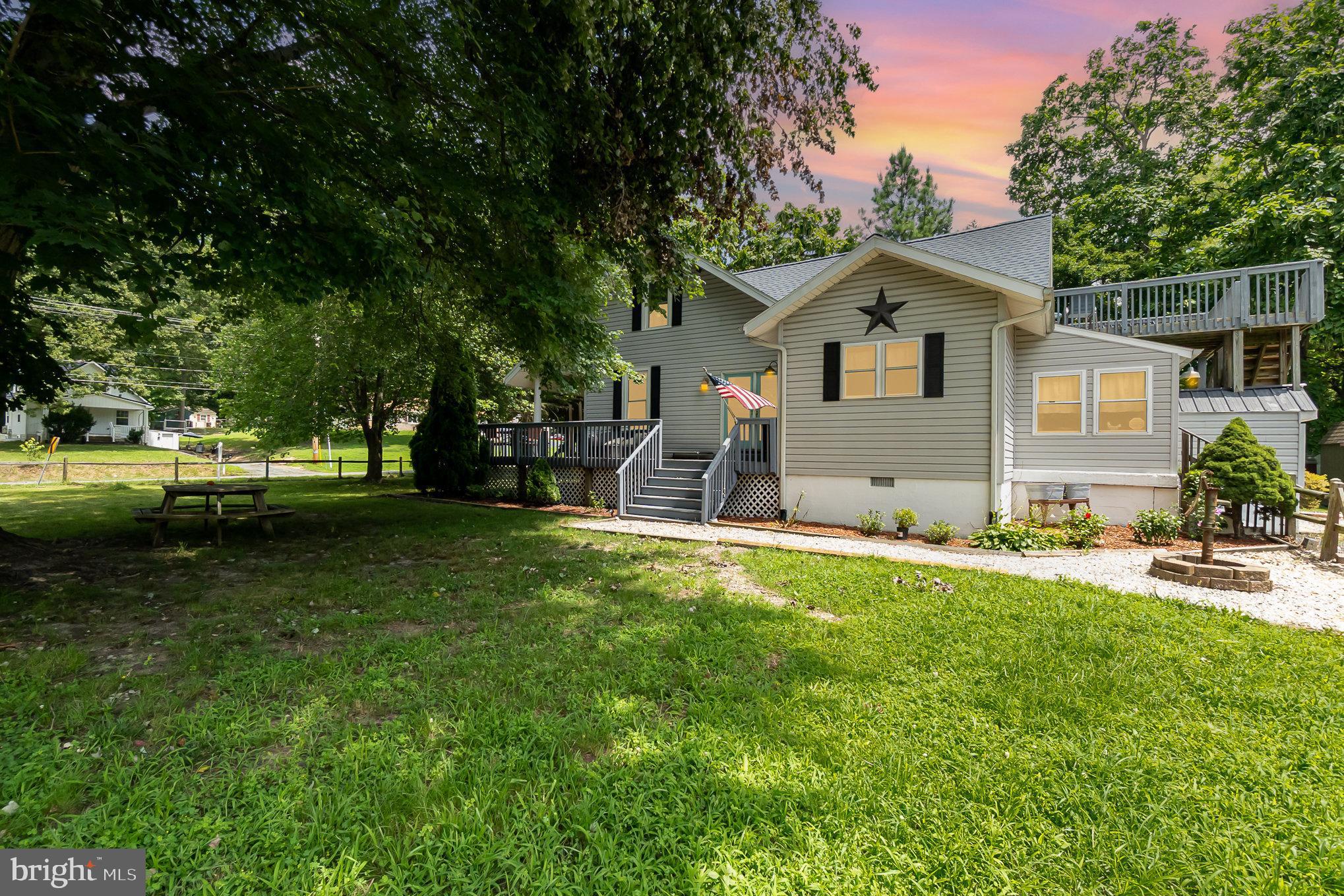 This warm and welcoming 1925 bungalow sits on 1.87 acres and is packed with character and modern updates. Inside, you’ll love the cozy living room with rustic wood beams and a woodstove—perfect for chilly nights. The home office is a great bonus, complete with built-in shelves and beautiful glass French doors. The kitchen has everything you need, including updated appliances, butcher block countertops, and a big pantry. The main bathroom is fresh and stylish with a new vanity and tiled shower/tub combo. There are two bedrooms on the main floor, plus a large utility room off the mudroom for extra space and storage. Upstairs, you’ll find two more bedrooms, including a spacious primary with its own private deck, and cedar closet. The upstairs bathroom is roomy and completely redone, featuring a relaxing garden tub, separate shower and double vanity. Outside, enjoy a big fenced yard, firepit area, detached one-car garage, and an extra-large driveway—plenty of room for guests, toys, or even a camper. Big-ticket updates are already done: new roof (2023), HVAC (2022), windows, water heater, well, and a whole-house water filter. If you’re looking for charm, space, and peace of mind—all just wrapped up in a classic bungalow—you’ll want to see this one!