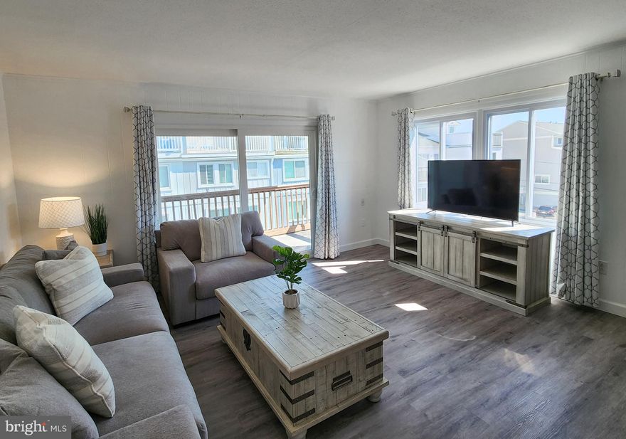 If location and sunshine are what you look for in a property, then this newly renovated 1 bed 1 bath is perfect for you. Slider, windows, AC/Split duct system are all brand new as of 2024. Large foyer for when you come off the beach and need to drop your gear. Beautiful beach barn door entryway into a large bedroom with plenty of storage in all new furniture that conveys. Fresh and crisp bathroom with ceramic tile and new LVP flooring throughout. Open concept living and dining room with new quartz kitchen countertops, all new stainless-steel appliances, new washer and dryer and brand-new living room furniture, all convey. Step out onto your large balcony and watch the waves crash or take a few steps out to the beach. This is a must buy in Ocean City and the epitome of move in ready.