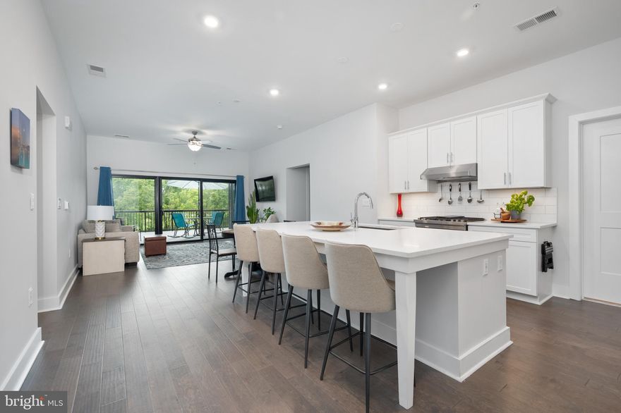 Welcome to your new luxury condo, located at One Central Park Condominiums in Ashburn, Virginia. 

One Central Park residents enjoy exclusive access to a rooftop terrace with a cozy outdoor seating area, a 2-sided gas fireplace, and a gas grill. Additionally, they have membership privileges at The Club at One Loudoun, which includes a swimming pool, tennis courts, sand volleyball court, and half-court basketball. These exceptional amenities enhance the living experience and offer a wide range of recreational opportunities.

Unit 208 features 2 bedrooms + den and 2 full bathrooms with gleaming hardwood flooring throughout. The modern gourmet kitchen boasts stainless steel appliances, quartz countertops, and an expansive center island with extended breakfast bar for any fast-paced mornings. The pristine white cabinetry showcases a clean and timeless look, elevating the space and providing plenty of storage. Highlighted by 3 grand glass doors, the living room was designed with comfort in mind and is entirely illuminated by the natural light streaming through, creating a bright airy feeling throughout the home. 

The terrace is 693 square feet with a stunning view of a tree conservation area, providing the perfect outdoor space for entertaining. The towering trees offer a serene and picturesque setting, creating the ideal space for simply unwinding after a long day, as well as enjoying morning cups of coffee and evening beverages. 

The primary suite features its own private entrance to the terrace, as well as an ensuite bathroom. The ensuite bathroom is spacious with a large walk-in closet, double vanities and lavish glass shower with dual shower heads and resting bench. The 2nd bedroom is generously sized as well and is served by the 2nd full bathroom. The den provides the ideal work-from-home space, and can always be transformed into a guest suite if you choose. The possibilities within this luxury condo are truly endless!

This condo also comes with a full-size laundry room with a front-loading washer and dryer, as well as a rinse sink, vanity with folding counter and cabinet storage underneath.

Look no further; you are home!