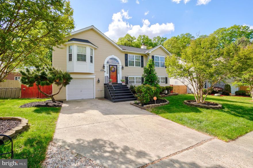 Nestled in a secluded, mature neighborhood in Suitland, MD, this beautifully maintained split foyer home with garage offers comfort, style, and convenience. The semi-open floor plan features vaulted ceilings in the living area and luxury vinyl flooring throughout the living room, dining room, kitchen, and hallway, creating a bright and cohesive main level.

Just off the dining room open your french doors and step onto a private 14x14 deck—perfect for outdoor dining or quiet relaxation. The recently updated kitchen boasts modern backsplash, and upgraded countertops. The main level has been freshly painted and is complemented by a brand-new roof with a transferable 50-year warranty, offering peace of mind for years to come.

The spacious primary bedroom serves as a true retreat, featuring a walk-in closet, vaulted ceilings, a large jacuzzi spa tub, and a cozy sitting area ideal for a home office or reading nook. The lower level provides a generous recreation area with a wood-burning fireplace, additional bedroom, and an impressive spa-inspired bathroom with an oversized shower.

From the lower level, walk out to a beautifully landscaped, fully privacy fenced backyard complete with a large covered patio for entertaining, plus an additional covered space perfect for quiet moments surrounded by nature. This serene outdoor setting is ideal for both hosting gatherings and unwinding at the end of the day.

Conveniently located within a short walk or quick drive to the Suitland Metro, commuting is effortless. With easy access to Suitland Parkway, I-295, and I-495/95, Washington, DC and Virginia are just minutes away. Whether you’re heading to MGM and National Harbor for entertainment or Tyson's Corner for shopping, this home offers an exceptional location to match its charm.