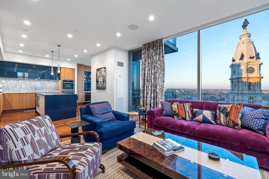 Nestled within The Ritz-Carlton Residences, this exceptional home is a rare gem. Meticulously crafted by combining two units, it seamlessly blends classic and modern design under the expert guidance of Young Huh Interiors of NY, an AD100 designer. Boasting captivating cityscape vistas, this residence offers a spacious layout replete with upgrades and luxury extras, making it a must-see for discerning buyers.

Upon entry, a luminous foyer adorned with Ann Sacks tile flooring sets the tone. The living room, bathed in natural light, affords breathtaking views of Philadelphia's skyline and the serene Delaware River, complemented by a private balcony for outdoor enjoyment. The Poggenpohl custom kitchen is a culinary haven, featuring Cambria Quartz countertops, a large island, and top-of-the-line Gaggenau induction cooktop, Miele ovens, microwave, dishwasher, refrigerator, and freezer. Adjacent, a cozy breakfast area offers sunrise vistas over City Hall, perfect for morning coffee or evening relaxation.

The primary bedroom suite continues the theme of luxury with panoramic views, a built-in bed unit, dual walk-in closets, and an opulent bath boasting a Baltic Leisure infrared sauna, radiant flooring, rain shower, and Poggenpohl double vanity. Additional bedrooms with ensuite baths provide comfort for family and guests, while entertainment awaits in the media room and wine bar featuring a 792-bottle cellar by Joseph and Curtis. Throughout, custom built-ins, designer lighting, and curated wall coverings enhance the ambiance, while a Savant smart-home system controls lighting, shades, TVs, surround-sound, and automated drapes. For those seeking turnkey convenience, the option for fully furnished acquisition, excluding artworks, is also available.