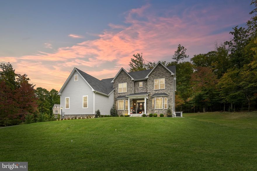 Discover luxurious living within the highly sought-after Urbana Schools district in this Grossnickle custom-built masterpiece. Featuring 5 bedrooms and 3.5 baths, this home is a captivating retreat for those who value privacy but want to be near great amenities. Set on a sprawling 5.16-acre wooded lot at the end of a freshly paved driveway, this home offers a serene escape from the hustle and bustle of daily life and still provides easy access to both Frederick and Montgomery Counties. 

The heart of this home is a gourmet chef's dream kitchen, replete with stainless steel appliances, including a custom-built side-by-side fridge/freezer, a wine fridge, and a top-of-the-line commercial-grade range. A large quartz kitchen island and a spacious walk-in pantry complete this culinary haven, making it the ideal space for hosting memorable gatherings.

As you step into the two-story great room with a tray ceiling, a grand stone wood-burning fireplace takes center stage, infusing the space with warmth and character. The main floor also offers the convenience of a guest bedroom, providing accessibility for first-floor living.

Upstairs, a grand wall of windows floods the hallway with natural light and a view of the tree-filled yard. Here you'll find the luxurious primary suite with two large walk-in closets with a spa-like bathroom featuring both a shower and a soaking tub. Two additional spacious bedrooms share a jack-and-jill bathroom with dual sinks, plenty of cabinetry, and an upgraded custom-tile shower. The last bedroom features an en suite bathroom. The second-floor laundry room, equipped with a utility sink, adds to the convenience of daily life.

The walk-up basement features plenty of space for storage and is waiting for you to customize it with your own touches. Outdoors, a private patio beckons for entertaining, while an extended 3-car garage provides ample space for your vehicles and storage needs. This home seamlessly combines luxury, comfort, and convenience, offering a unique opportunity to experience the best of both worlds.