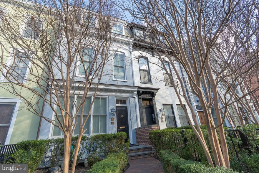 Introducing a meticulously renovated Dupont Circle residence that seamlessly blends historic character with cutting-edge engineering, offering four bedrooms, four-and-a-half baths, and approximately 3,861 finished square feet across four levels. High ceilings without soffits, impact-rated windows and doors, extensive custom millwork, and a private elevator serving all levels reflect exceptional craftsmanship and livability throughout. The main level features a gracious entry foyer, formal living and dining rooms, a state-of-the-art gourmet kitchen with breakfast nook, and an airy family room with powder room. French doors open to a beautifully designed rear patio with wood-burning fireplace, outdoor speakers, TV, heat lamps, mister fans, and gas grill—perfect for year-round entertaining. Heated front and rear walkways, along with heated steps to the lower level, are thoughtfully integrated alongside irrigated planter beds, ensuring ease of maintenance in every season. The home is equipped with integrated control systems for lighting, audio, climate, water, and security, including a comprehensive camera system—delivering a high level of comfort, control, and peace of mind. Whole-house water filtration further enhances daily comfort. The second level hosts two spacious bedrooms with ensuite baths and custom closets, including one with a private terrace. Lush irrigated greenery provides privacy along the glass-filled sitting area. The entire third floor is devoted to the primary suite, featuring dual walk-in closets, a spa-inspired bath with heated floors, sauna, and steam shower, and direct access to a private rooftop terrace surrounded by irrigated greenery engineered to support a hot tub. The lower level offers a recreation room, a temperature-controlled wine cellar with dedicated AC, an additional bedroom, and full bath, creating a versatile guest or leisure suite. The level also includes mechanical provisions for a future efficiency kitchen. Completing the home is a rare all-steel two-car garage thoughtfully engineered to support a future second-story apartment or swimming pool. Above it, a lush irrigated garden terrace creates a private outdoor retreat—an elevated extension of the home ideal for relaxing, entertaining, or enjoying quiet moments above the city. For added flexibility and investment potential, the fully renovated 3-unit apartment building next door (MLS #DCDC2249252) is also available. It features a large one-bedroom unit and two two-bedroom, two-bath units—perfect for rental income, extended family, or staff accommodations—creating a rare opportunity to acquire a premier Dupont Circle compound.