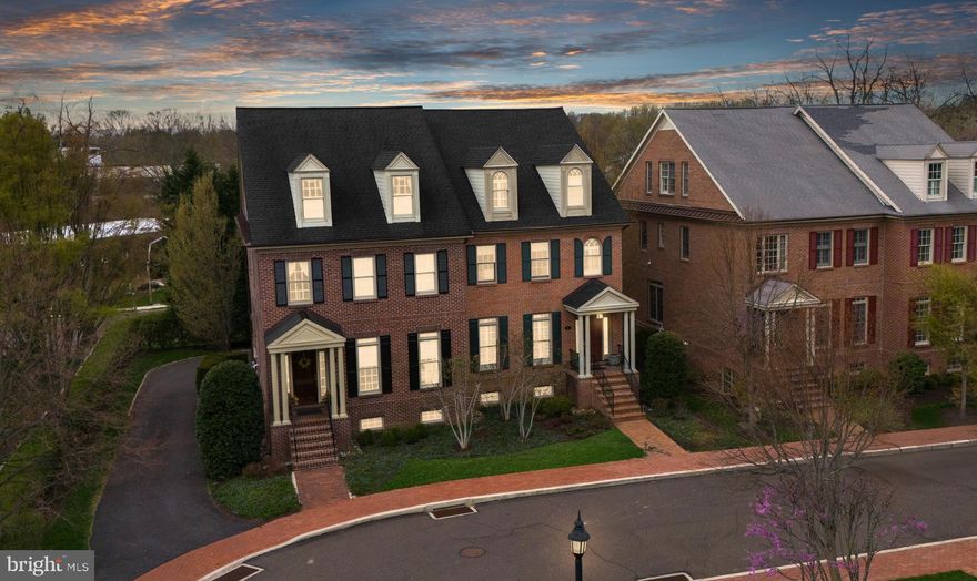 Nestled in the prestigious Phillips Court enclave, this stunning all-brick reproduction home offers an exceptional blend of timeless elegance and modern luxury—just steps from the vibrant shops and dining of charming Newtown Boro. Thoughtfully curated with high-end finishes and custom upgrades throughout, this residence is a true masterpiece of craftsmanship and sophistication.

Step inside to discover rich, site-finished hardwood floors, intricate millwork, and exquisite moldings that lend a sense of grandeur and style to every room. Sunlight pours in through oversized windows, creating a bright and inviting ambiance throughout the open floor plan.

The gourmet kitchen is a chef’s dream—anchored by a large center island and outfitted with premium stainless steel appliances including a 6-burner Dacor gas cooktop, Gaggenau steamer, double wall ovens, and a warming drawer. Granite countertops, extensive custom cabinetry, and a walk-in pantry ensure both beauty and functionality.

Entertain effortlessly in the elegant formal dining room, which features built-in cabinetry seamlessly integrated behind refined trim. The formal living room showcases a gas fireplace with designer surround and opens to a private deck—perfect for al fresco dining and summer gatherings.

Upstairs, the luxurious primary suite is a private retreat featuring dual custom walk-in closets, a built-in window seat with storage, and a spa-inspired bathroom with an expansive steam shower, dual vanities, and exquisite tile work. A dedicated office space and stylish laundry room complete the second floor. The third level offers two additional bedrooms (or one bedroom and a loft) and a beautifully appointed full bath.

The fully finished lower level is an entertainer’s paradise, featuring a state-of-the-art home theater with stadium seating, a wet bar, and generous flex space. For your comfort and convenience, an elevator services all levels of the home.

Additional highlights include a two-car garage and low-maintenance luxury living—all in an unparalleled location just moments from everything Newtown Boro has to offer. This exceptional residence is truly one-of-a-kind—where elegance, comfort, and location converge.