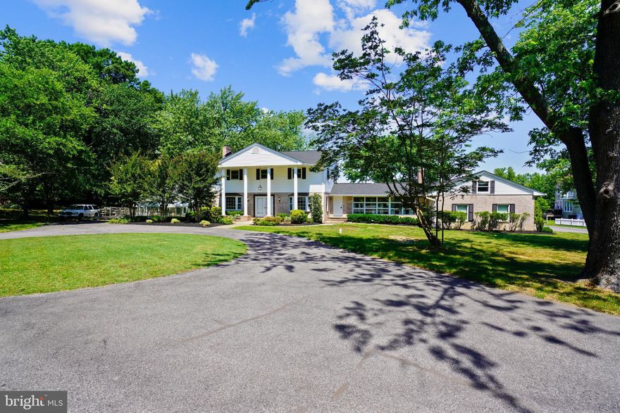 Stately Colonial Situated on 4.2 Acre Waterfront Lot Which includes Pier, 2 RARE BOATHOUSES, Circular Driveway with Plenty of Parking, Three Car Garage,  26 x 45 Detached Barn With 3 Stalls Which Could Be Used For Horses, The Car Enthusiast or a  Potential Pool House, Main Level Bedroom  Features Updated Full Bath & Exposed Wood Ceilings & Cozy Fireplace, Large Gourmet Kitchen With Double Center Islands Is Perfect for Entertaining & Features Wolf & Sub Zero Appliances, Granite Countertops, Skylights and Fireplace, Living Room Right off The Kitchen and Separate Dining Room, 2 Large Bonus Rooms Which Could Be Used For Family Room/Living Room/Piano Room/Office, Upper Level Includes Spacious Primary Bedroom with En Suite Bath and Two Additional Bedrooms & Full Hall Bath, Lower Level Includes Two Bonus Rooms and Large Recreation Area With Walk Out. 
The 4.2 Acre Property is Serene.  Imagine having Your Friends & Family Events On The Patio At The Pool & Then Going for a Boat Ride. With Beautiful Views of Whitemarsh Creek all within the South River School System.