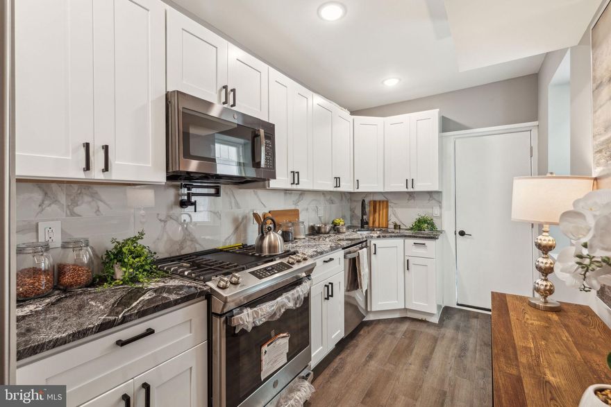 Welcome to this stunning renovation in EAST KENSINGTON! Step inside and discover a thoughtfully updated interior. The comfortable living area, with its modern gray hues and tasteful wall art, flows seamlessly into a dining space perfect for entertaining. Imagine preparing meals in the sleek, modern kitchen featuring crisp white cabinetry, black cabinet pulls, stainless steel appliances, and black quartz countertops.

Upstairs, find serene 3 bedrooms and 2 FULL BATHROOMS offering a peaceful retreat. The contemporary bathroom boasts stylish tiling and modern black fixtures. A primary suite with ensuite bathroom is conveniently located at the front of the house. Descend to the fully finished basement, a versatile space housing the laundry and home systems, and offering exciting potential for your home office, gym, or ultimate game room!

Enjoy your own large private outdoor space, ideal for relaxing or entertaining friends/family. Located with convenient access to major highways like I-95 and Route 1, commuting is a breeze. You'll also find public transportation options nearby like the L stop taking you into center city along close access to FISHTOWN and local parks, restaurants, and gyms. Plus — this property qualifies for the Bank of America grant, a fantastic opportunity for eligible buyers!