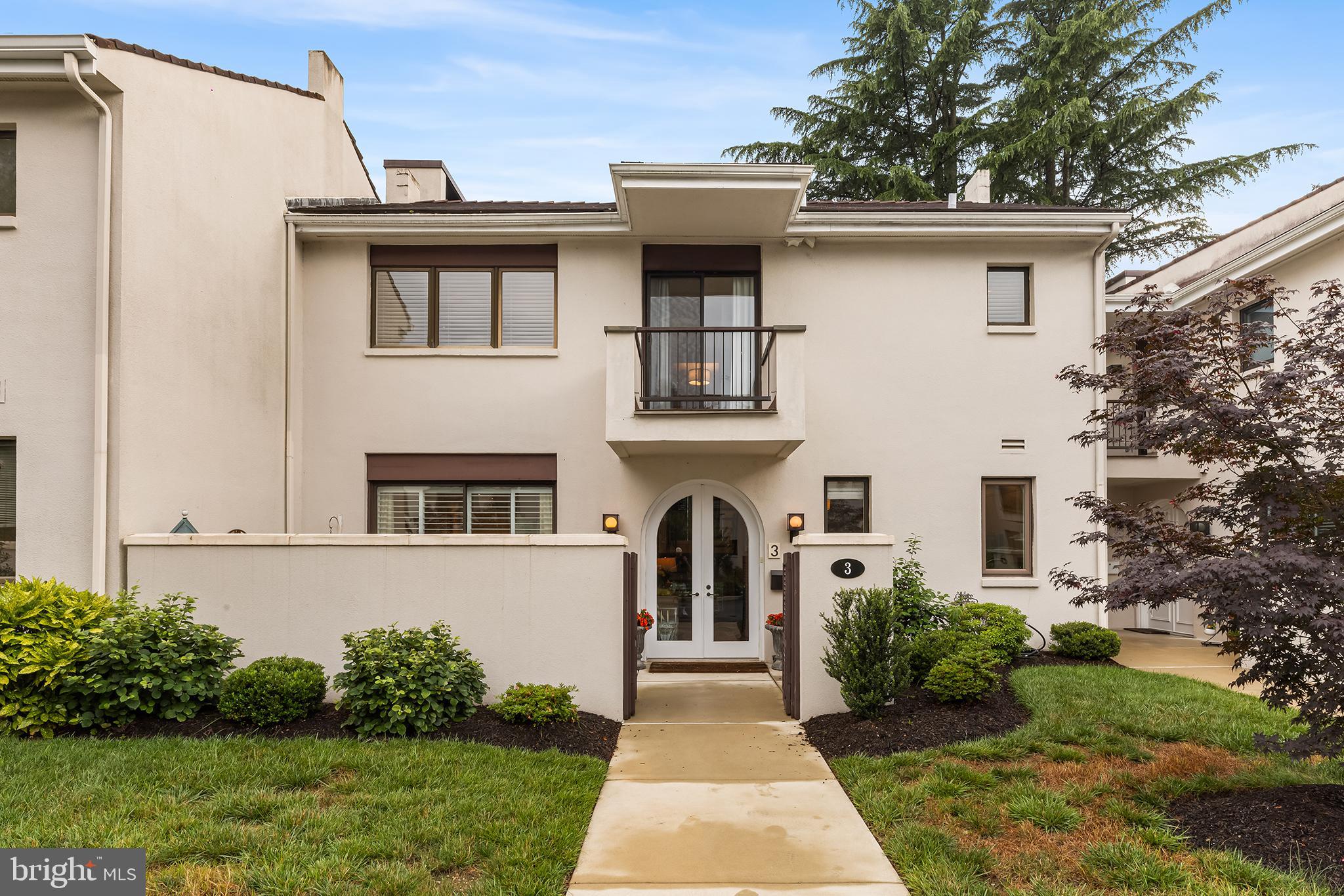 Welcome to timeless elegance and the charming French-inspired community of Arbordeau. This townhome is perfectly situated in the development with walkability to the community pool, clubhouse and nearby Jenkins Arboretum. Outside of the community, you’ll find plenty of shops, parks, top-rated schools, transportation and more. Step through the double arched front doors into a private walled courtyard, surrounded by lush gardens—your own tranquil retreat. Inside, the main level offers a spacious living room with a wood-burning fireplace, recessed lighting, and gleaming hardwood floors. The updated kitchen features floor-to-ceiling cabinetry, stainless steel appliances, and granite countertops. This home flows into a generously sized dining room, complete with a built-in sideboard and sliding doors to a beautifully landscaped rear stone patio. Upstairs, you'll find three spacious bedrooms. The primary suite is a true retreat with double doors, abundant closet space, a private balcony overlooking serene gardens, and a newly remodeled en-suite bath with a double vanity, soaking tub, and a newer shower. In this primary bedroom is a stackable washer/dryer and very convenient for laundry day chores. The second bedroom also includes a private balcony and closet. The third bedroom offers afternoon sunshine and lots of closet space. The lower level connects directly to the underground garage with two dedicated parking spaces, a mudroom, cozy TV/lounge area and another room with ample storage. Enjoy comfort, convenience, and classic style in a peaceful Devon setting—this townhome has it all!