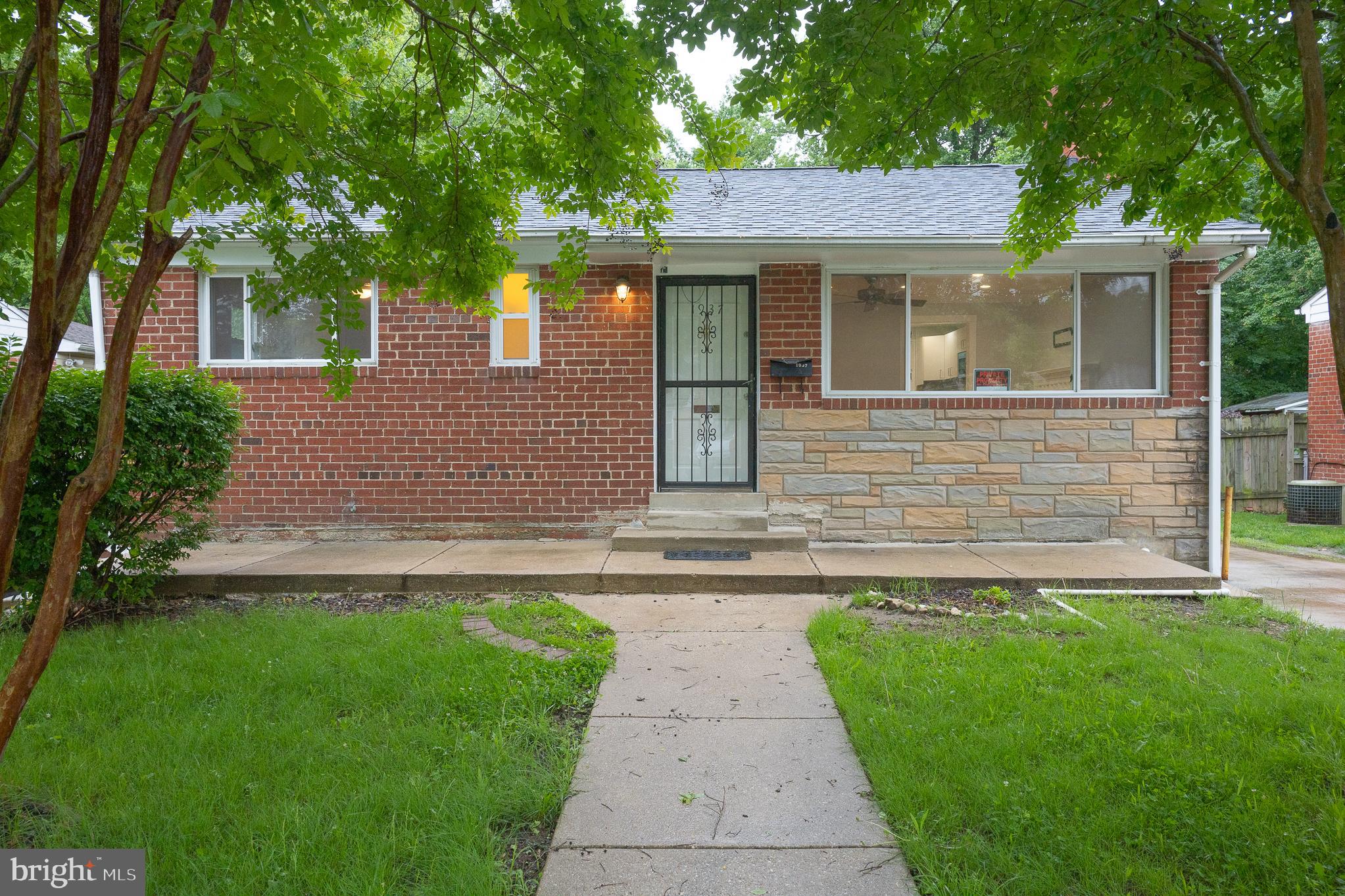 Welcome to this bright brick home with endless possibilities for an in-law suite or multigenerational family. The updated white bay kitchen is furnished with slate counters, stainless steel appliances and ceramic tile floors. The main level also provides a spacious living room with hardwood floors, a wood-burning fireplace, and a ceiling fan/light. One full bath and three bedrooms with ceiling fans and hardwood floors complete the main level. The walk-out lower level features a recreation room and a second full kitchen with oak cabinets, appliances, and a breakfast bar. The basement also includes two additional bedrooms, a full bathroom, and a utility room equipped with a full-size washer and dryer. The home has updated vinyl windows, a new architectural shingle roof, and a detached oversized garage. Easy access to MetroBus and convenient location to downtown DC, Baltimore and Annapolis, in close proximity to the Metro, MARC rail and major transportation routes. Owner is looking for 680+ credit scores and $102k gross annual income. Call Marty today for a private showing of this lovely home, which is available for immediate occupancy. Rental application link is https://apply.link/tAqpx_Y