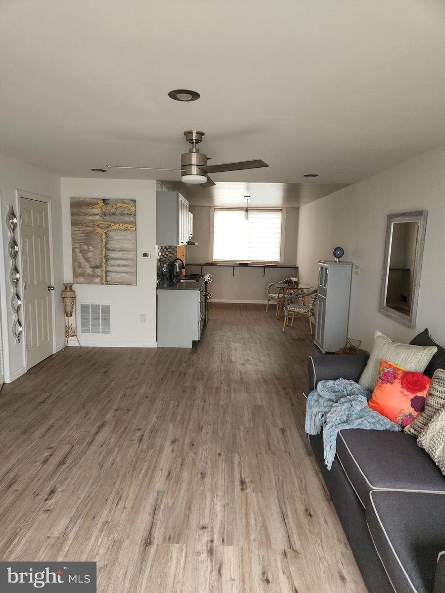 This is it. The one you've been waiting for. This house is like Goldilocks and the Three Bears...Just Right! Not too big. Not too small. Just enough style without being overly re-done.  Open concept floor plan, yet super cozy. Home sweet home. There are 2 ways to enter the home in the front. There's your traditional front door plus a brand new custom double-wide patio door on the ground level. So if you don't feel like walking up a flight of steps just to get in the door after a long day's work, this home is for you. Imagine opening up the patio doors to entertain your guests, taking full advantage of the outdoor space.  Very convenient also when moving bulk furniture in. Tons of natural light flows in from the front and back. Home sweet home. Everything is at your fingersteps. There's a powder room on the ground level. Next to the powder room is a storage closet. Luxury tile goes all the way from the livingroom to the kitchen. The kitchen has solid surface countertops with a gorgeous backslash. Beautiful glass pendant lighting. New cabinets. All new replacement windows throughout. Large picture window with custom window covering. The new stainless steel refrigerator is tucked away in its own custom nook so it's not an eye sore or in the way of traffic going in and out while cooking. There's an extra long counter at the rear of the kitchen that can be used for eating, extra prep space, displays, or work-from-home station. Beyond the kitchen you'll find a brand new full size washer and dryer. New gas stove. Original hardwoods lead upstairs to a spacious master and 2 secondary bedrooms. All bedrooms have neutral gray carpet. The master and living room have ceiling fans. The master will easily accommodate a king-size bed. There's a storage closet in the hallway. The bathroom contains a linen closet, tub-to- ceiling tile, new tile floors, new toilet, designer faucet, and new Kohler vanity. You'll stay cool in the summer with central air and warm in the winter with central gas heat. There's plenty of street parking but you have your own private parking in the rear on your parking pad. The back yard is fenced.  Are you worried about leaky, flooding basements after a heavy rain? No worries. Not here. Fall in love with this unique, 2-level, sensible floorplan. Not to mention this home is on a quiet, dead end street which adds to privacy. Close to schools, shopping, and major commuter routes. This home won't last long. Schedule your appointment today. You will be pleasantly pleased. Pictures do not do it justice. This Frankford neighborhood home is perfect for new homeowners.  Closing help is available with acceptable offer.