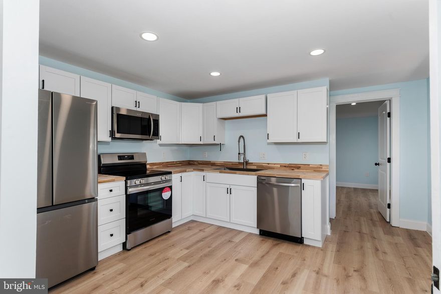 Embrace the walkable lifestyle of Chestertown in this completely renovated downtown gem from 1900. Experience both historic charm and modern amenities as this home has all brand new plumbing, electrical, insulation, HVAC, and roofing. Make the most of one floor living with the beautifully designed first floor owner's suite. The ensuite owner's bathroom comes with a tastefully tiled walk-in shower.  Double doors open right from the suite onto the covered side porch that wraps around to a private back deck. An all new kitchen is awaiting your culinary pursuits while the open floor plan drawing you to the living room remains  flooded with natural light from the tall historic windows. The second floor has two generous sized bedrooms and another new full bathroom. The front bedroom has a staircase up the finished third floor hobby room.  The rear yard is fenced, shaded and ready for your next cookout. Off street parking is another added bonus to this property.  Enjoy the perfect balance of historic and upgraded with this catch just a few blocks from Chestertown's shops, culture and waterfront.